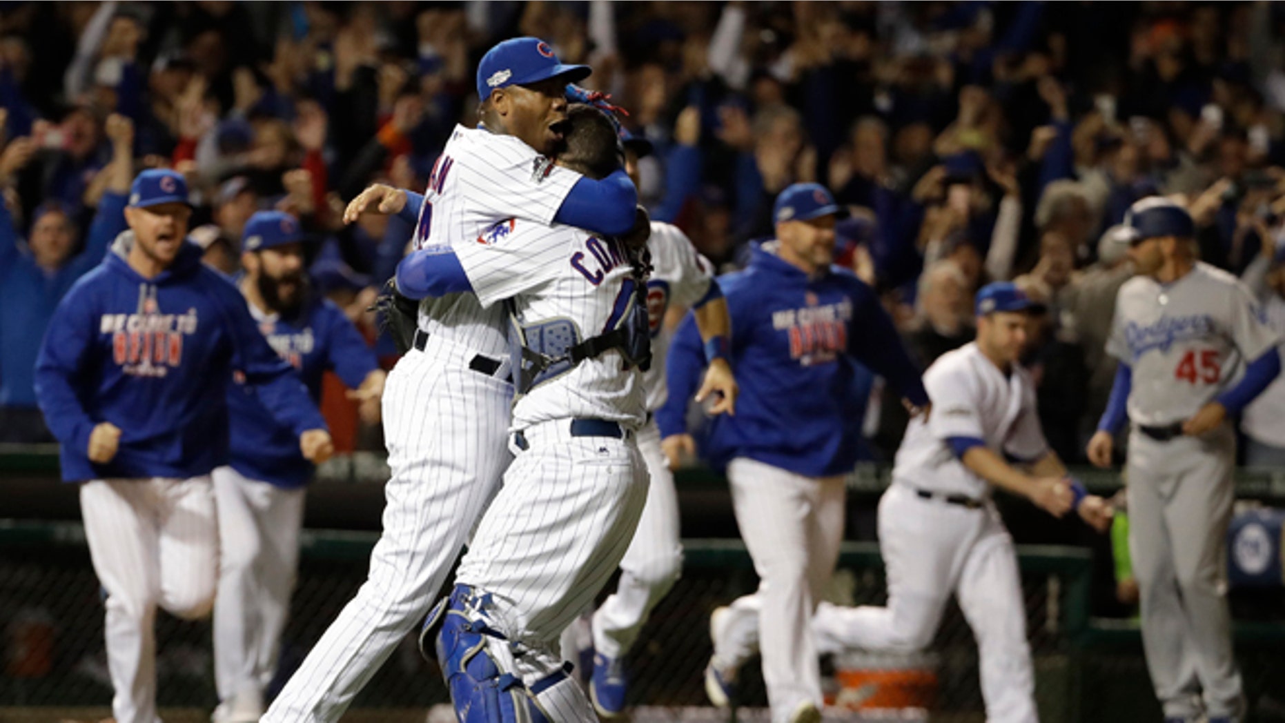 Chicago Cubs catcher Willson Contreras and relief pitcher Aroldis Chapman (54) celebrate after Game 6 of the National League baseball championship series against the Los Angeles Dodgers Saturday, Oct. 22, 2016, in Chicago. The Cubs won 5-0 to win the series and advance to the World Series against the Cleveland Indians. (AP Photo/David J. Phillip)