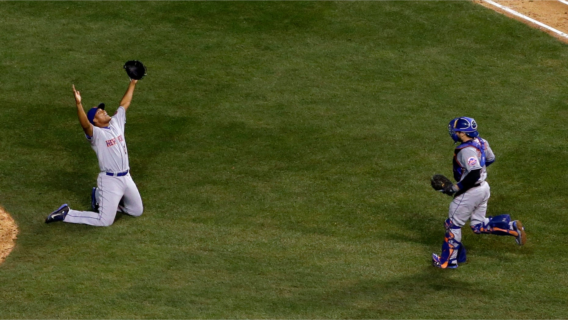 New York Mets pitcher Jeurys Familia, left, and catcher Travis d'Arnaud celebrates after Game 4 of the National League baseball championship series Wednesday, Oct. 21, 2015, in Chicago. The Mets won 8-3 to advance to the World Series. (AP Photo/David J. Phillip)