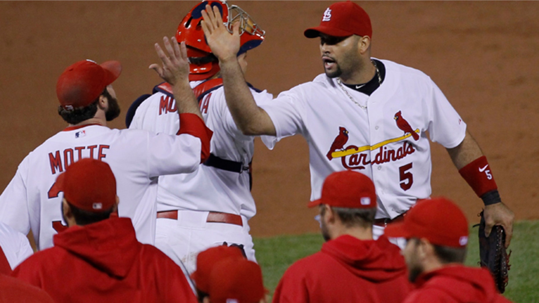 St. Louis Cardinals' Albert Pujols (5) celebrates with Jason Motte after the ninth inning of Game 3 of baseball's National League championship series against the Milwaukee Brewers Wednesday, Oct. 12, 2011, in St. Louis. The Cardinals won 4-3 to take a 2-1 lead in the series. (AP Photo/Charles Rex Arbogast)