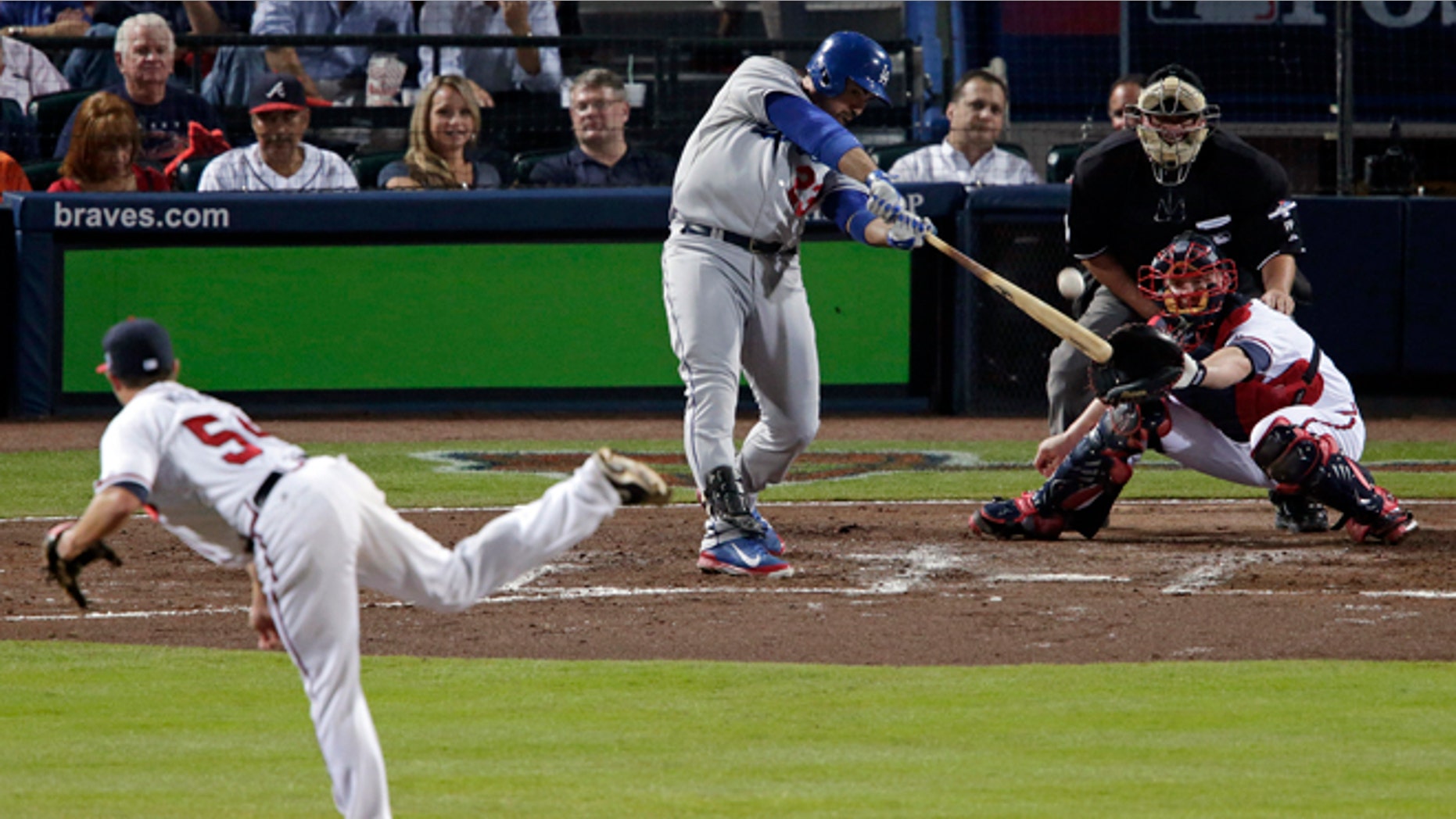 Los Angeles Dodgers Adrian Gonzalez (23) hits a two-run home run against the Atlanta Braves in the third inning of Game 1 of the National League Divisional Series, Thursday, Oct. 3, 2013, in Atlanta. (AP Photo/Dave Martin)