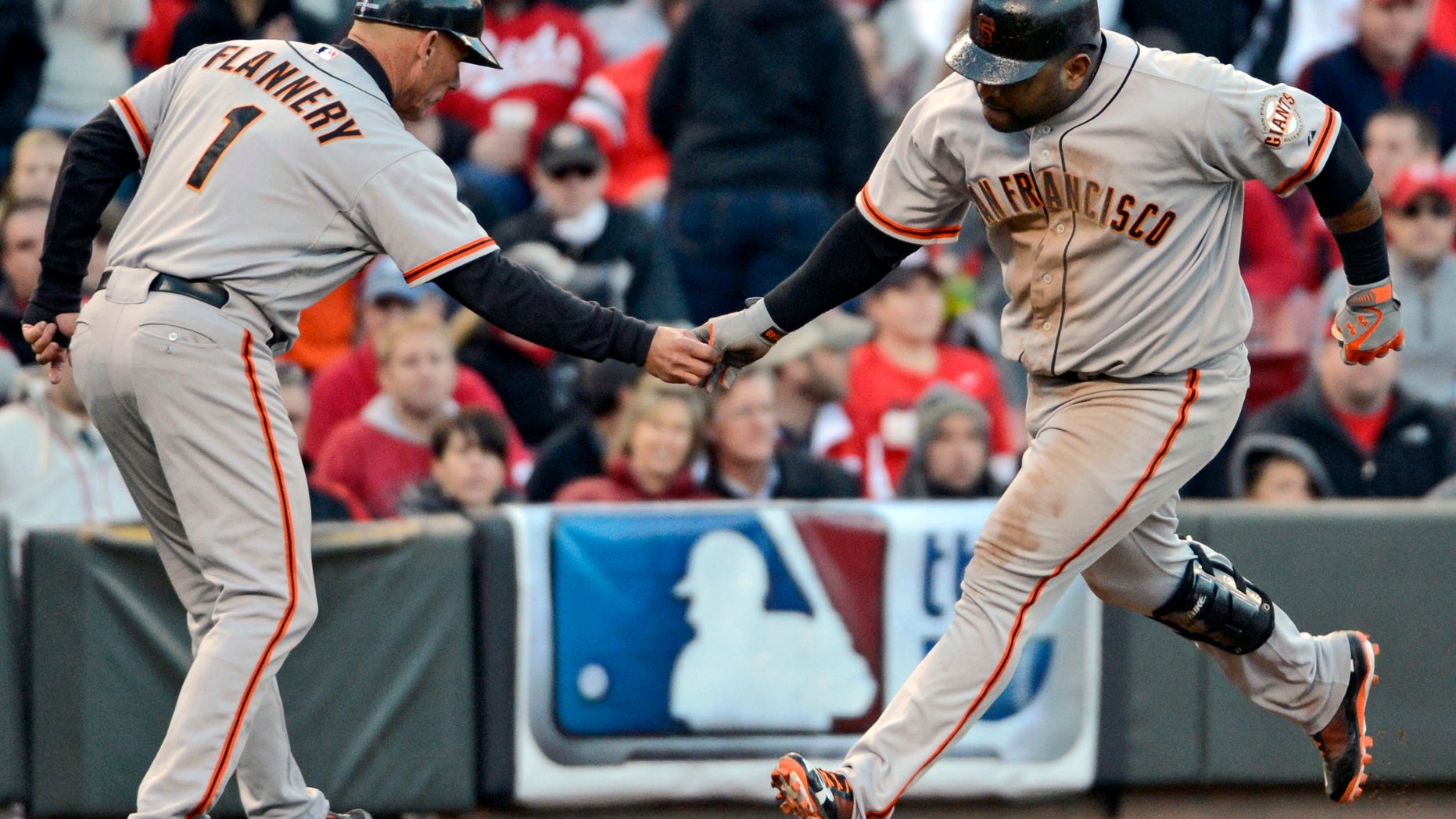Oct. 10, 2012: San Francisco Giants' Pablo Sandoval is congratulated by third base coach Tim Flannery (1) after hitting a two-run home run against the Cincinnati Reds in the seventh inning of Game 4 of the National League division baseball series, in Cincinnati.