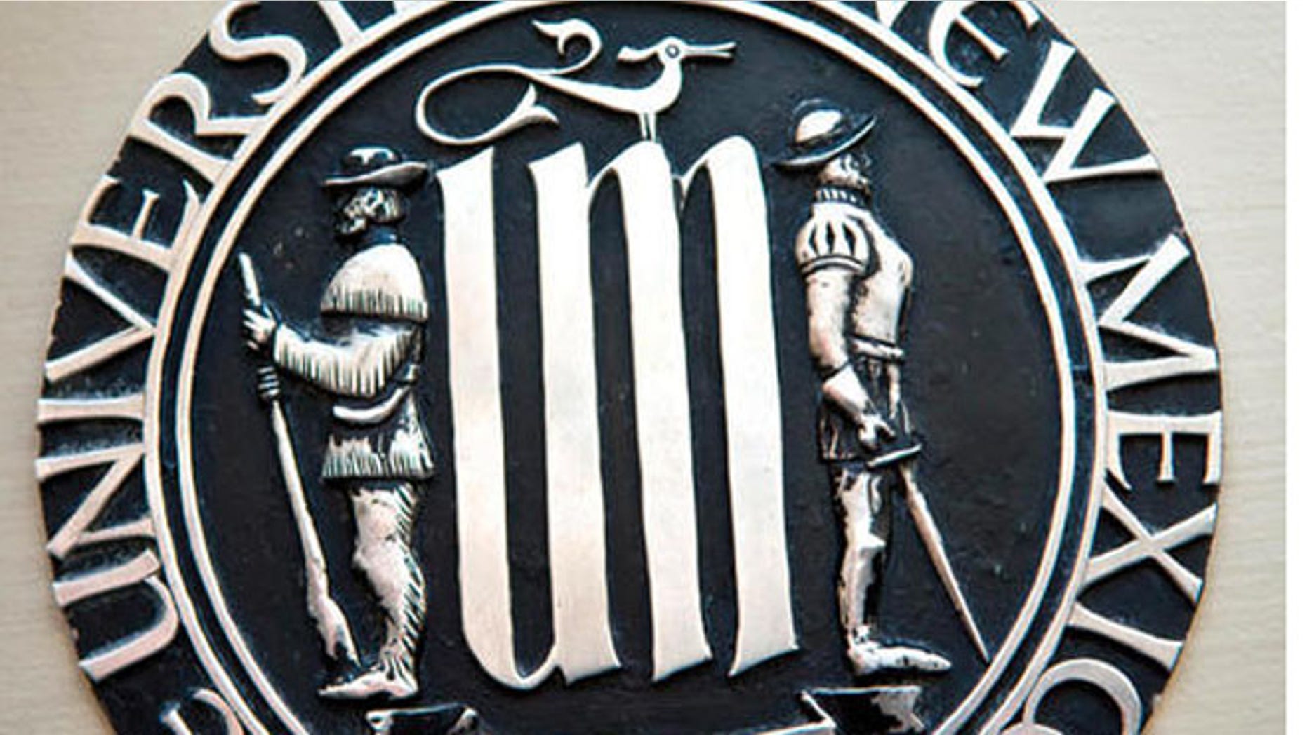 This undated photo shows the University of New Mexico's official seal, depicting a Spanish conquistador and a frontiersman, that is drawing accusations of racism from Native American students. New Mexico's largest university is considering revising its half-century old seal over concerns by Native American students who say it represents the frontier's violent era. (Marla Brose/Albuquerque Journal via AP