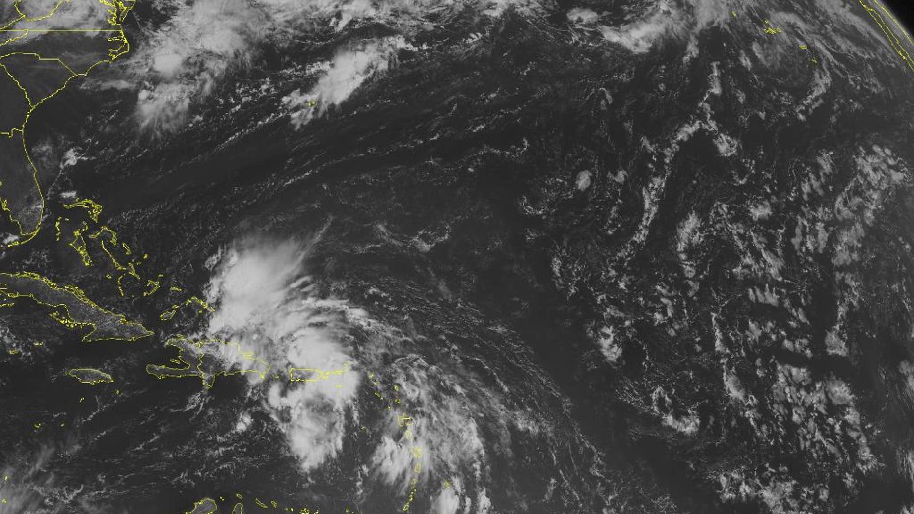 This NOAA satellite image taken Friday, Aug. 22, 2014 at 10:45 a.m. EDT shows a widespread area of disorganized clouds, ranging from the Turks and Caicos to Lesser Antilles, associated with a potential developing tropical depression near Puerto Rico. Generally fair conditions are dominating the remaining areas of the Caribbean region and central and northern Bahamas as well as Cuba. (AP Photo/Weather Underground)