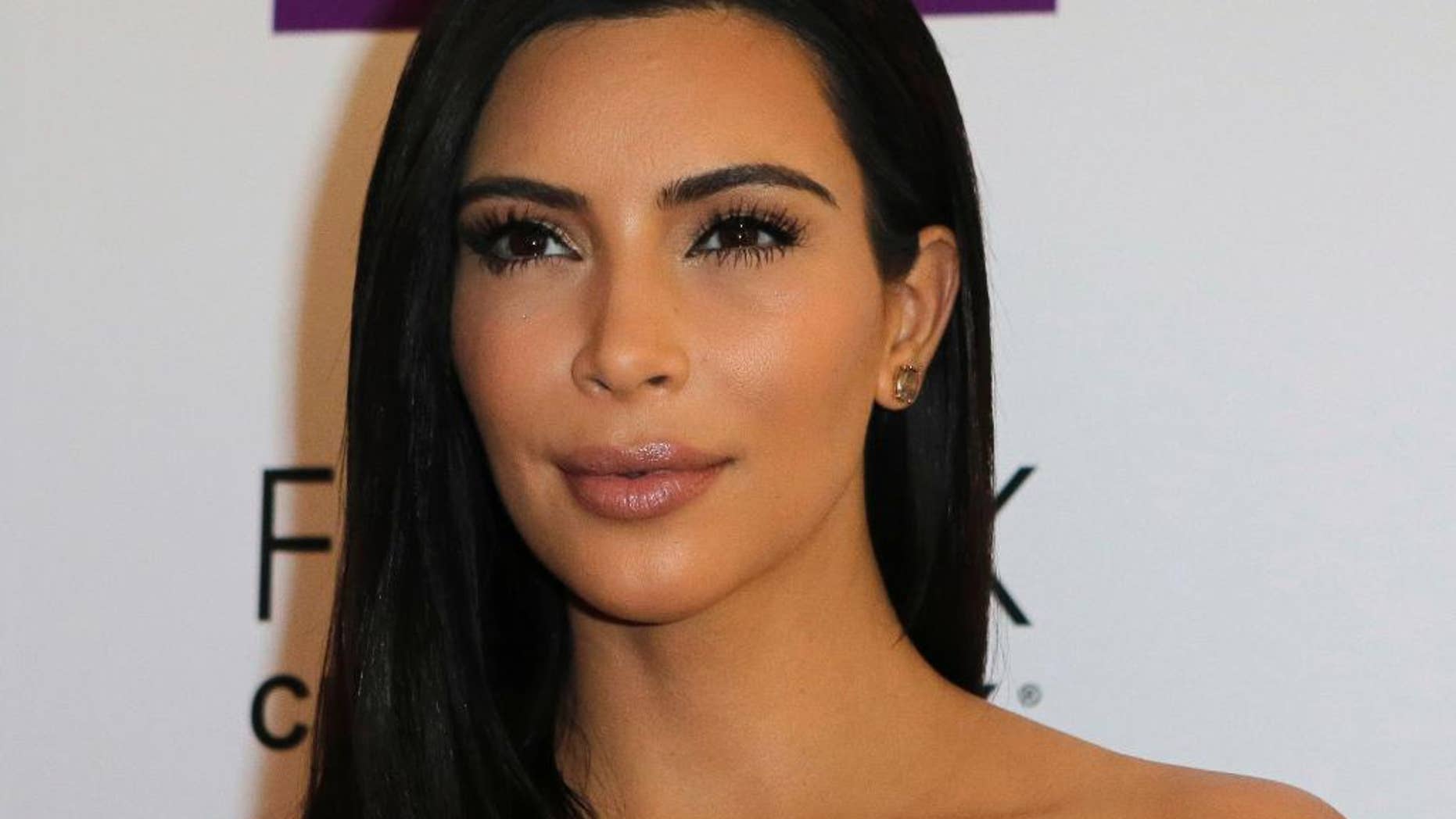 April 15, 2015. Kim Kardashian attends a photocall to launch hair products in Paris.