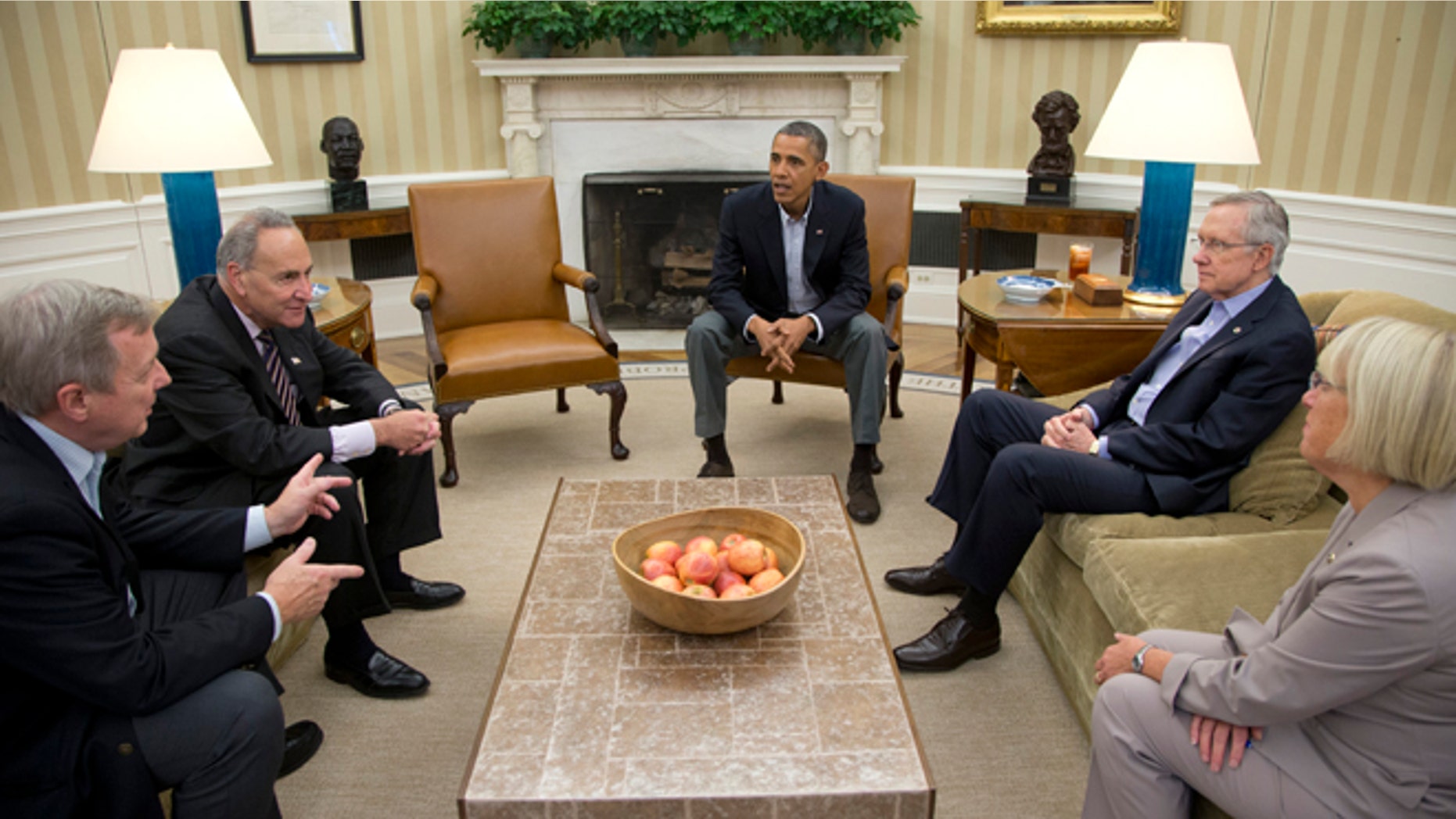 From left, Sen. Dick Durbin, D-Ill., Sen. Charles Schumer, D-N.Y., President Barack Obama, Senate Majority Leader Harry Reid of Nev., Sen. Patty Murray, D-Wash., meet in the Oval Office of the White House, Saturday, Oct. 12, 2013, in Washington. The federal government remains partially shut down and faces a first-ever default between Oct. 17 and the end of the month. (AP Photo/Carolyn Kaster)