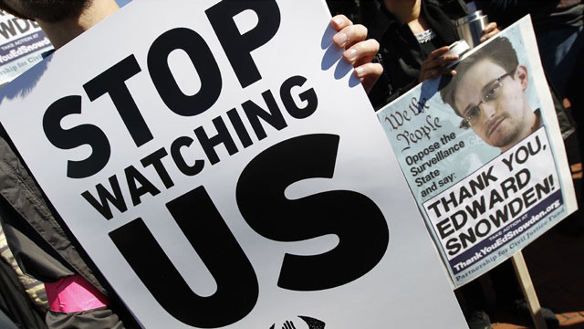 October 26, 2013: Demonstrators protest outside of the U.S. Capitol in Washington during a rally to demand that the U.S. Congress investigate the National Security Agency's mass surveillance programs. (AP Photo/Jose Luis Magana)