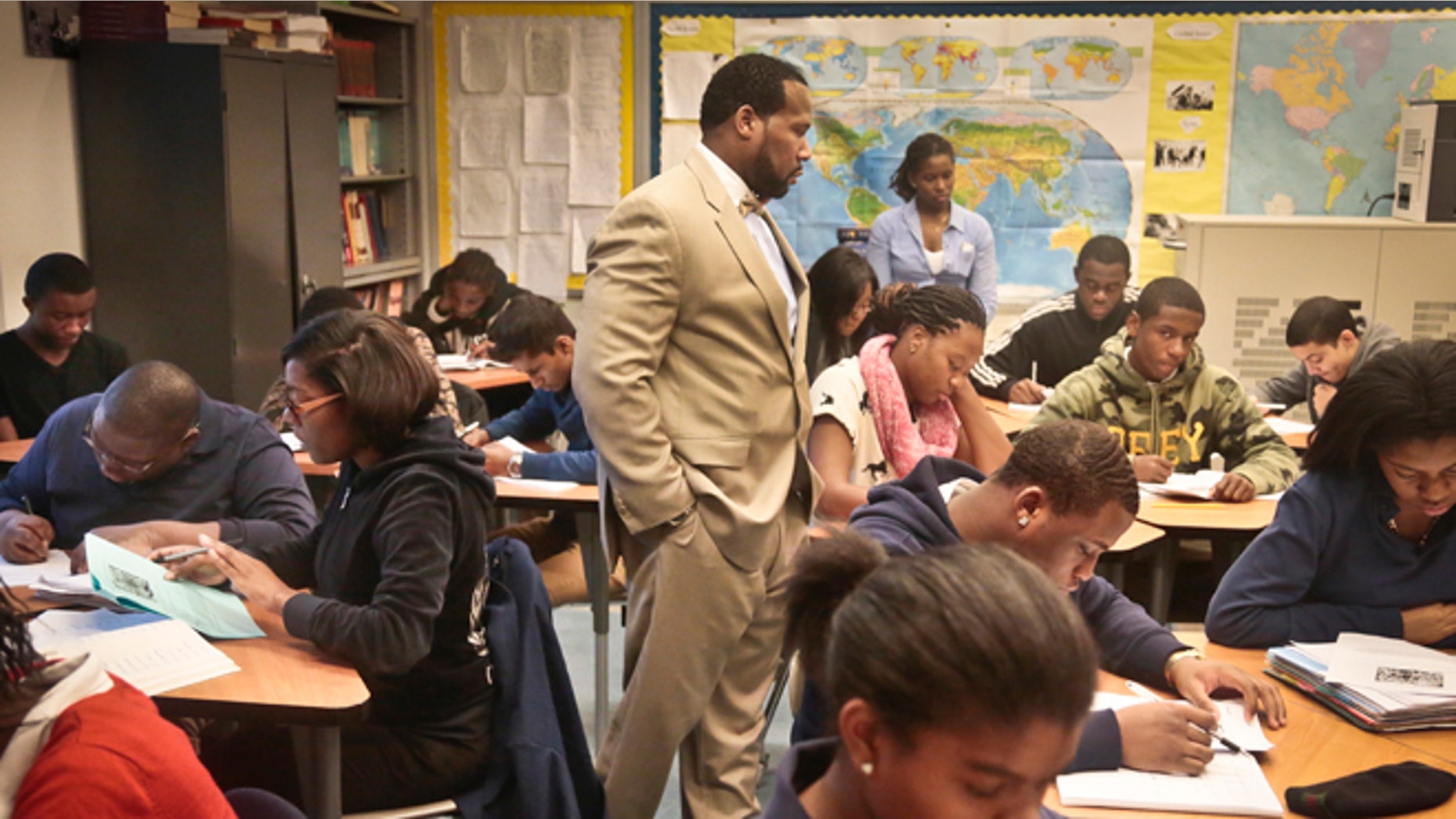 FILE - In this Dec. 3, 2013 file photo, Adofo Muhammad, center, principal of Bedford Academy High School, teaches 10th and 11th graders in his Global Studies class in the Brooklyn Borough of New York. New York state has the most segregated public schools in the nation, with many black and Latino students attending schools with virtually no white classmates, according to a report released Wednesday, March 26, 2014, by the Civil Rights Project at the University of California at Los Angeles. (AP Photo/Bebeto Matthews, File)