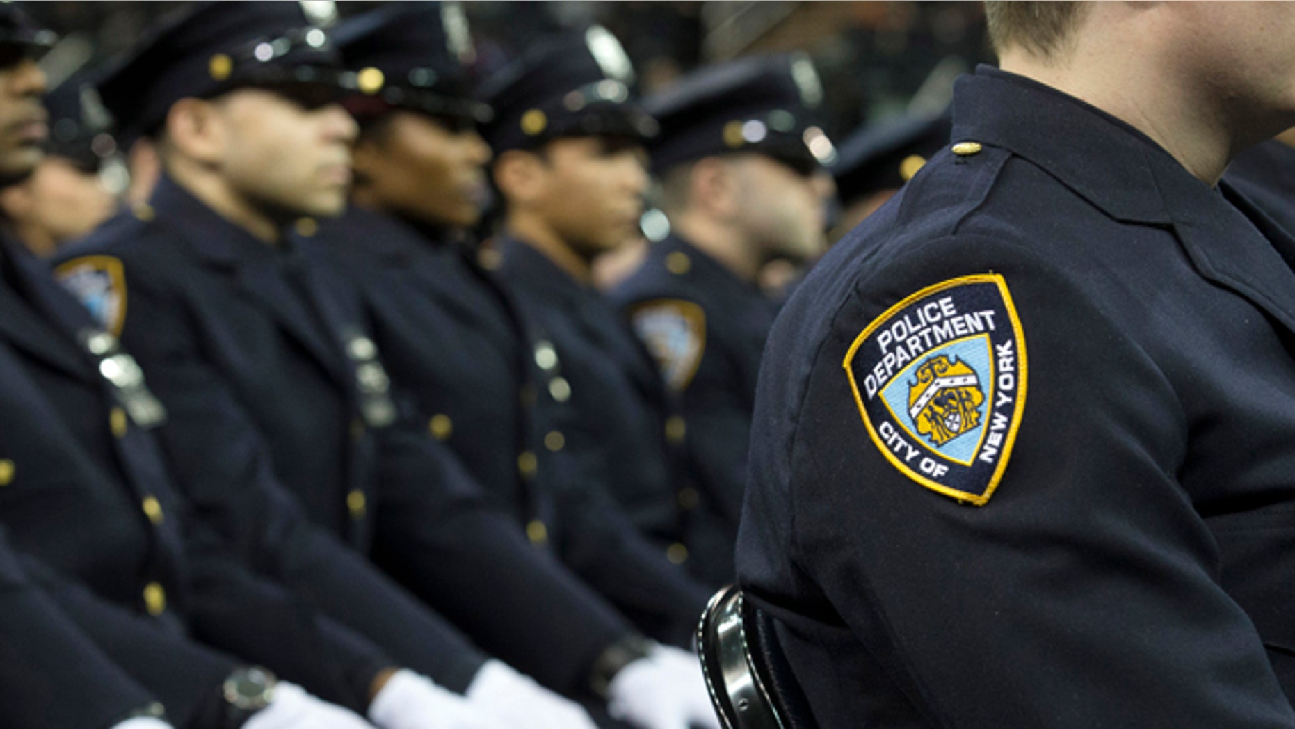 FILE- In this Dec. 29, 2014, file photo, new recruits attend their New York Police Academy graduation ceremony at Madison Square Garden in New York. (AP Photo/John Minchillo, File)