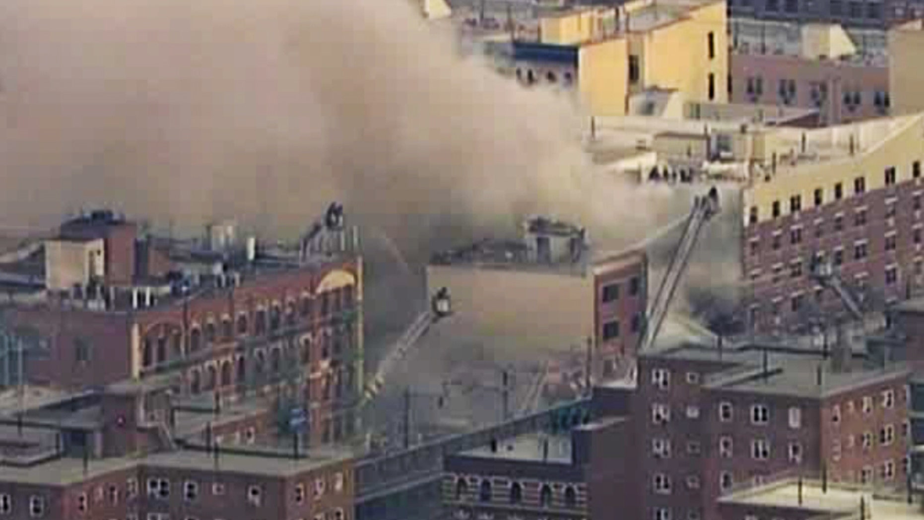 In this image taken from video from WABC, firefighters battle a blaze at the site of a possible explosion and building collapse in the East Harlem neighborhood of New York, Wednesday, March 12, 2014. (AP Photo/WABC-TV)
