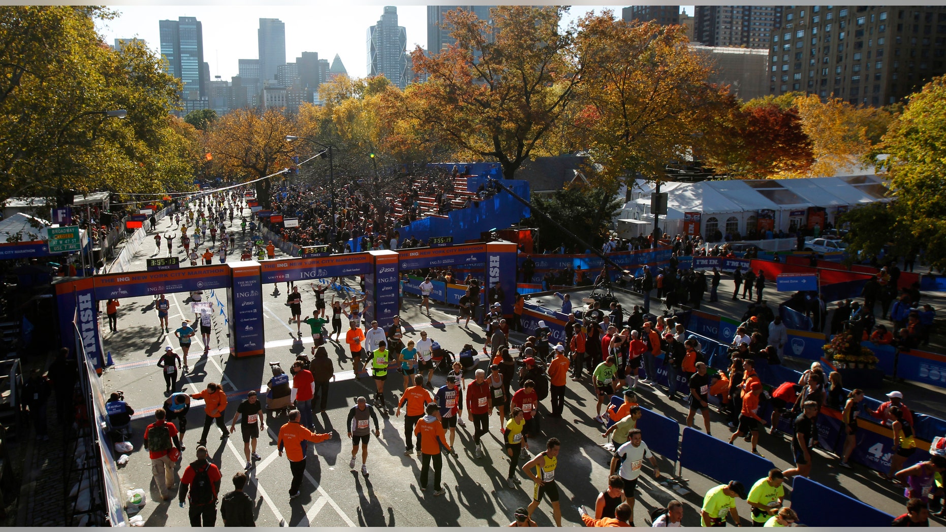 Runners cross the finish line at the end of the 2011 New York City Marathon in New York November 6, 2011.