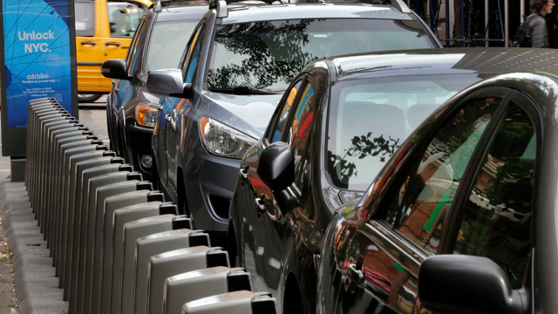 May 14, 2013: Dock and lock bike sharing stations are blocked by parked cars in New York's Chelsea neighborhood.