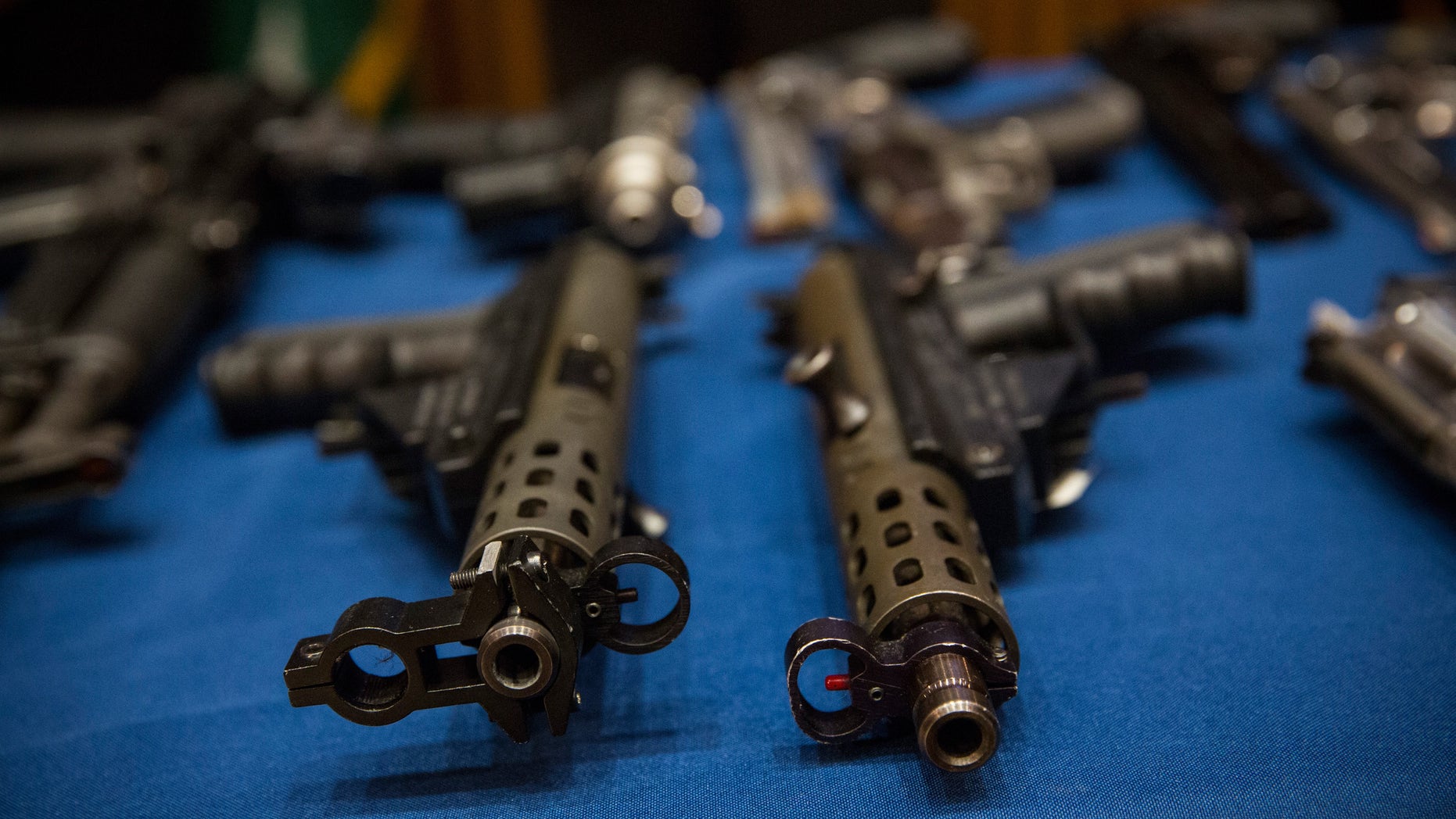 NEW YORK, NY - AUGUST 19: Guns seized by the New York Police Department (NYPD), in the largest seizure of illegal guns in the city's history, are displayed on a table during a press conference on August 19, 2013 in New York City. The operation, which involved an undercover agent buying guns that were smuggled from North Carolina and South Carolina, yielded over 250 guns. ninteen people have been charged in the operation. (Photo by Andrew Burton/Getty Images)