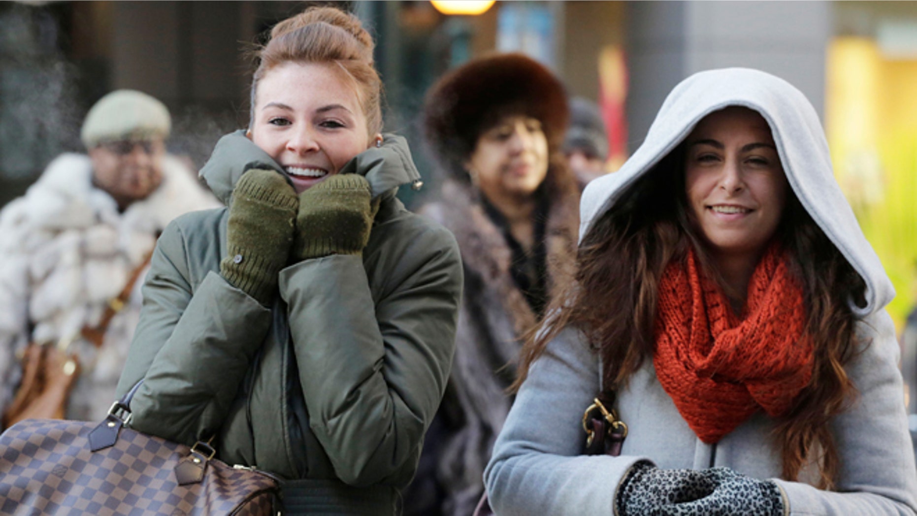 Women are bundled up against the cold on New York's 34th Street.