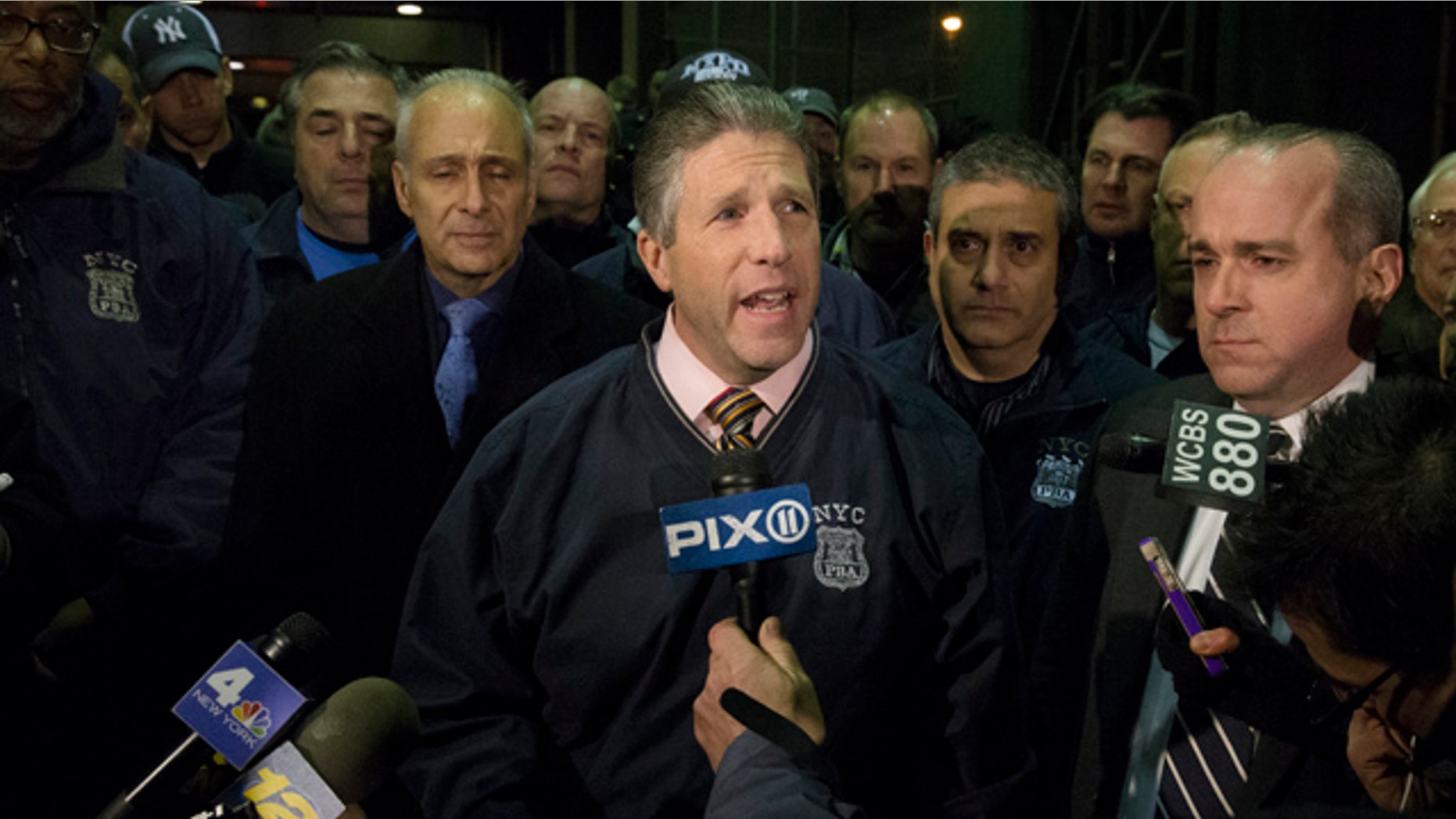 Dec. 20,2014: Patrick Lynch, head of the Patrolmen's Benevolent Association, speaks during a news conference after the bodies of two fallen NYPD police officers were transported from Woodhull Medical Center in New York. (AP Photo/John Minchillo)