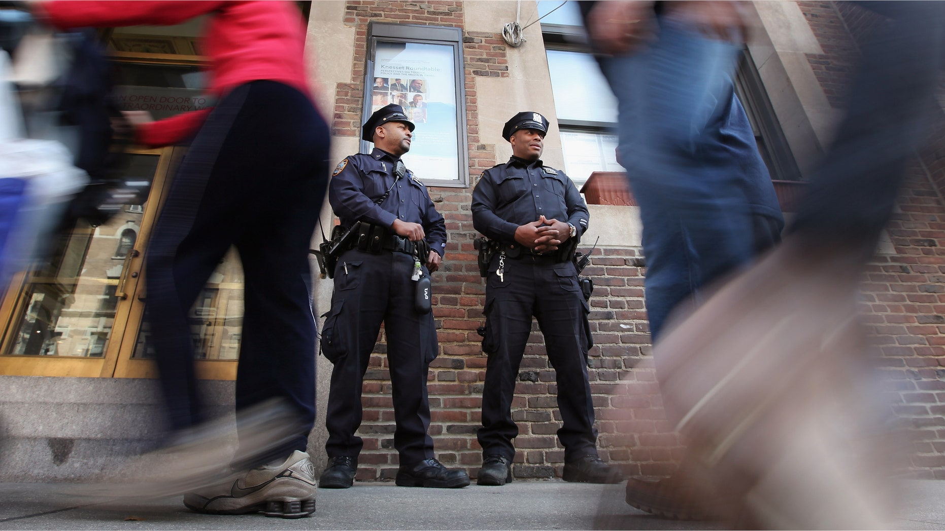 NEW YORK, NY - MARCH 20: New York Police Department officers keep watch outside the 92nd Street Y, a Jewish institution, in Manhattan on March 20, 2012 in New York City. Extra security has been added to Jewish sites around the city following the attack on a Jewish school in France that killed four people. (Photo by Mario Tama/Getty Images)