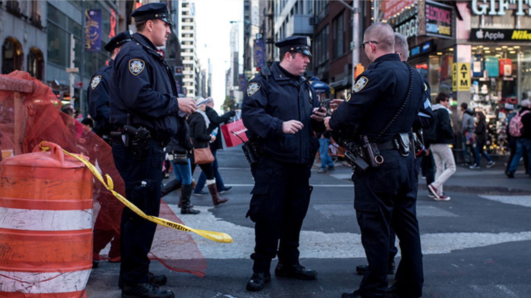 NEW YORK, NY - NOVEMBER 14: Police officers keep watch in Times Square following a series of terrorist attacks in Paris on November 14, 2015 in New York City. Security in New York City has increased following the coordinated assault on Paris which ISIS claimed responsibility for. At least 120 people have been killed and over 200 injured, 80 of which seriously. (Photo by Andrew Renneisen/Getty Images)