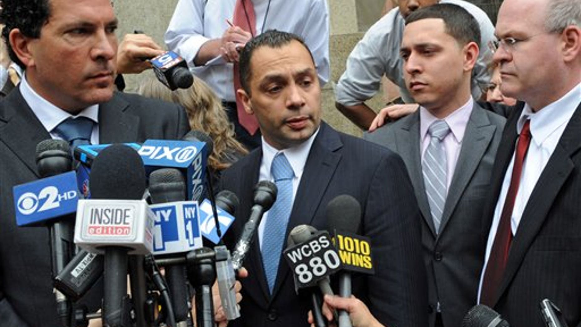 May 26: Police officer Ken Moreno, middle with co-defendant Franklin Mata, right, speak to the media outside Manhattan criminal court in New York.