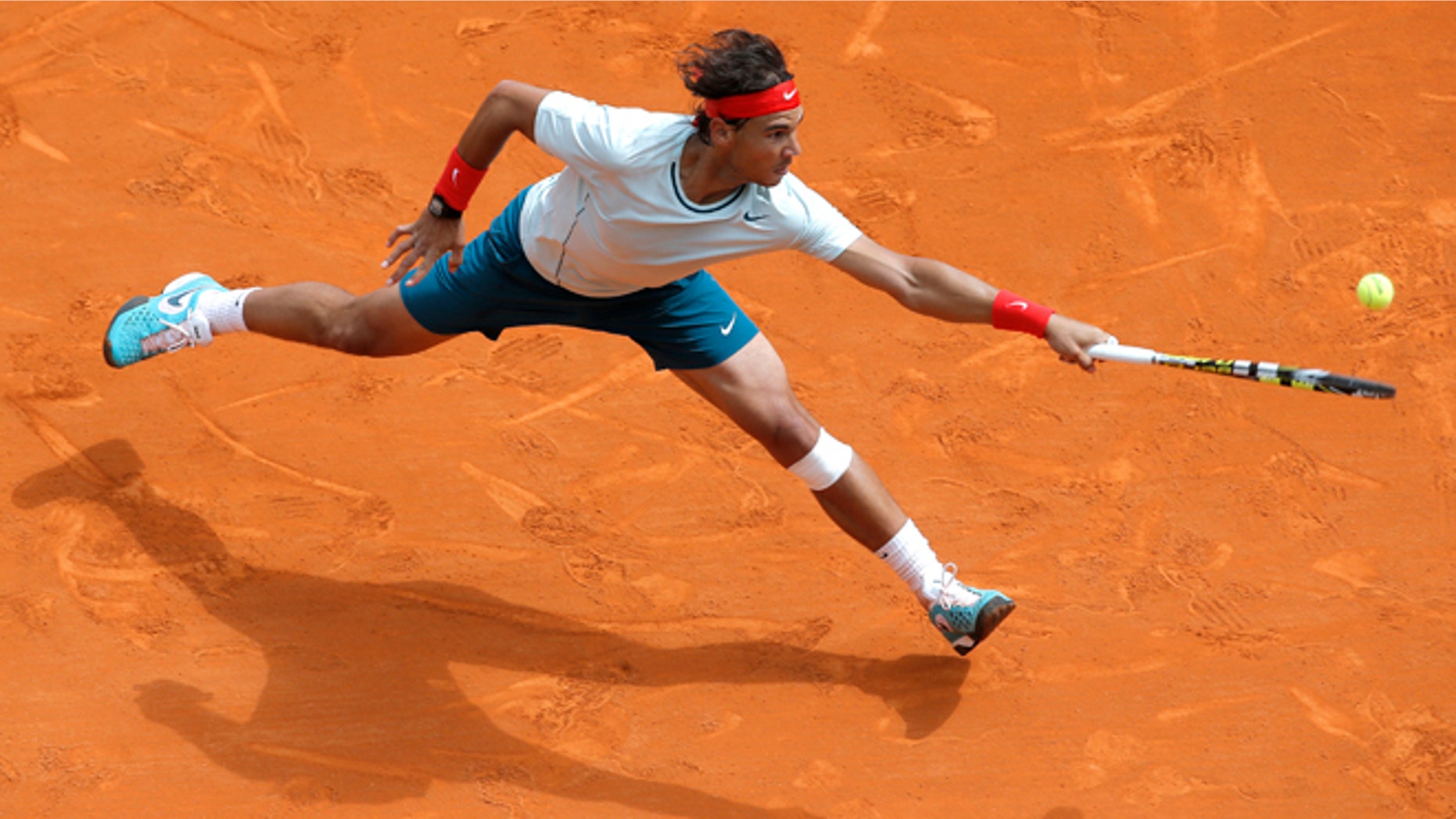 FILE - In this April 20, 2013 file photo, Spain's Rafael Nadal plays a return to France's Jo-Wilfried Tsonga during their semifinal match of the Monte Carlo Tennis Masters tournament in Monaco. Nadal already owns a record seven titles at Roland Garros. The French Open begins Sunday, May 26, 2013. (AP Photo/Lionel Cironneau, File)