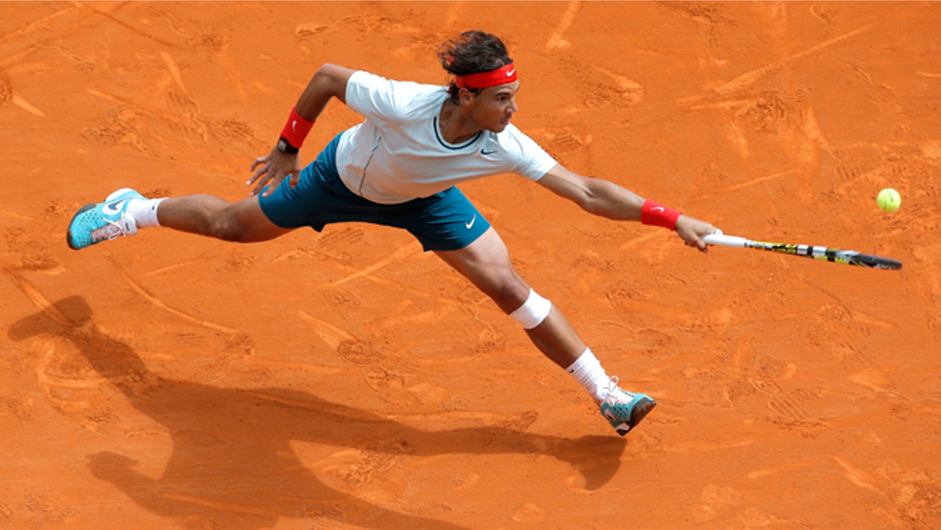 FILE - In this April 20, 2013 file photo, Spain's Rafael Nadal plays a return to France's Jo-Wilfried Tsonga during their semifinal match of the Monte Carlo Tennis Masters tournament in Monaco. Nadal already owns a record seven titles at Roland Garros. The French Open begins Sunday, May 26, 2013. (AP Photo/Lionel Cironneau, File)