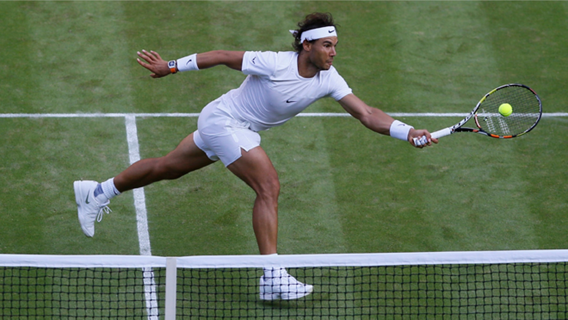 Rafael Nadal of Spain returns a ball to Dustin Brown of Germany, during their singles match at the All England Lawn Tennis Championships in Wimbledon, London, Thursday July 2, 2015. (AP Photo/Kirsty Wigglesworth)