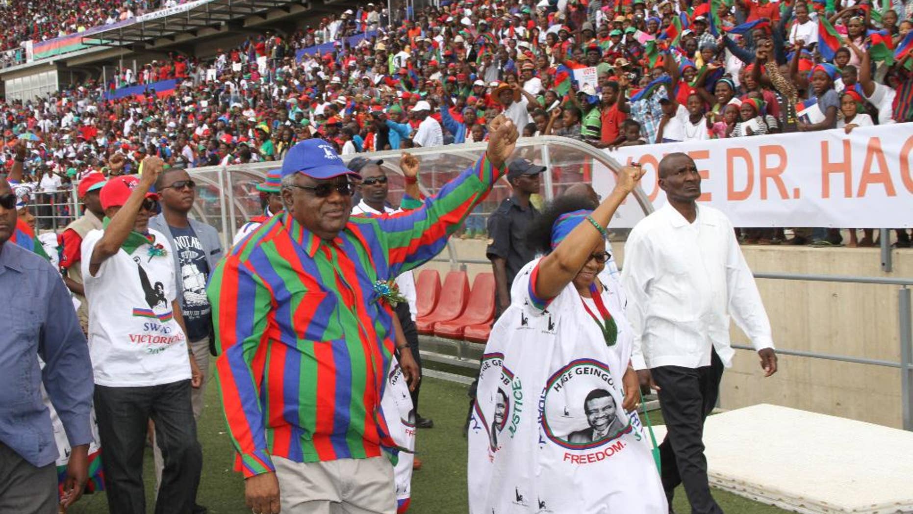 In this photo taken Saturday, Nov. 22, 2014, Namibian president Hifikepunye Pohamba, centre left, and his first lady, Penehupifo Pohamba, centre right, arrive at the Sam Nujoma Stadium in Windhoek, Namibia for an election rally. Namibians go to the polls Nov. 28 to elect a new president and national assembly. (AP Photo/Joseph Nekaya, Namibian Press Association)
