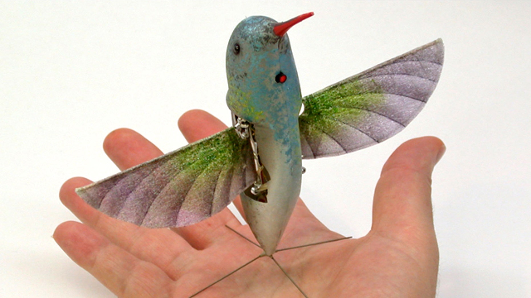 A robot hummingbird demonstrates precision hovering and independent. The two-wing, flapping aircraft carries its own energy source, and uses only the flapping wings for propulsion and control.