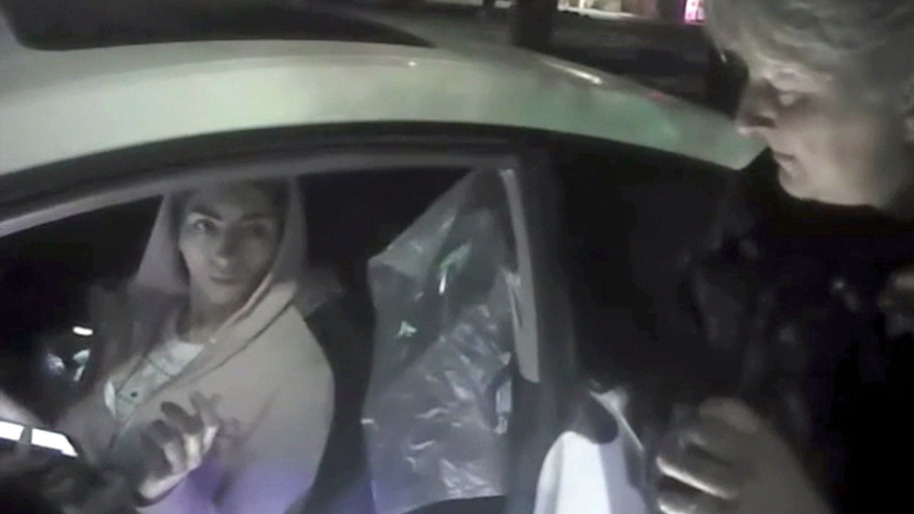 In this April 3 image from video provided by the Mountain View Police Department, Nasim Aghdam is questioned by officers after being found asleep in her car.
