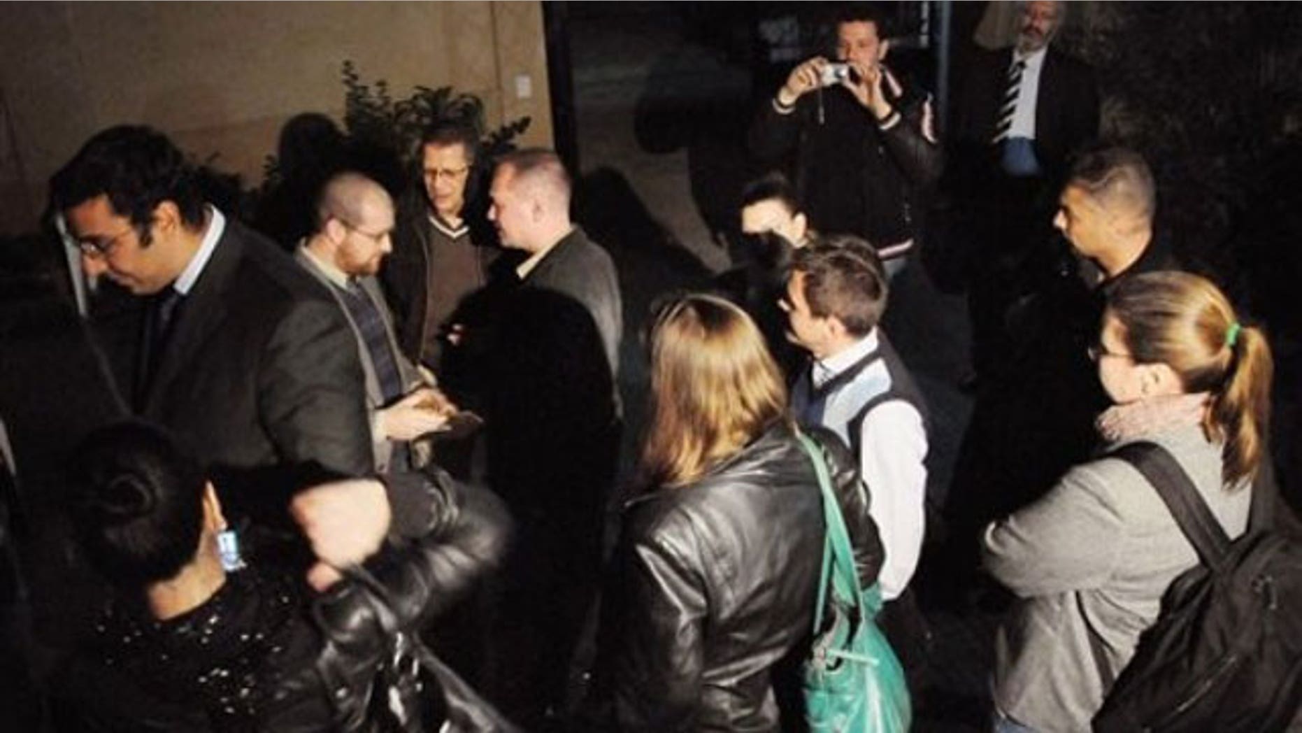 December 29, 2011: Workers from a non-governmental organization National Democratic Institute, or NDI, wait as Egyptian officials raid their office in Cairo, Egypt.