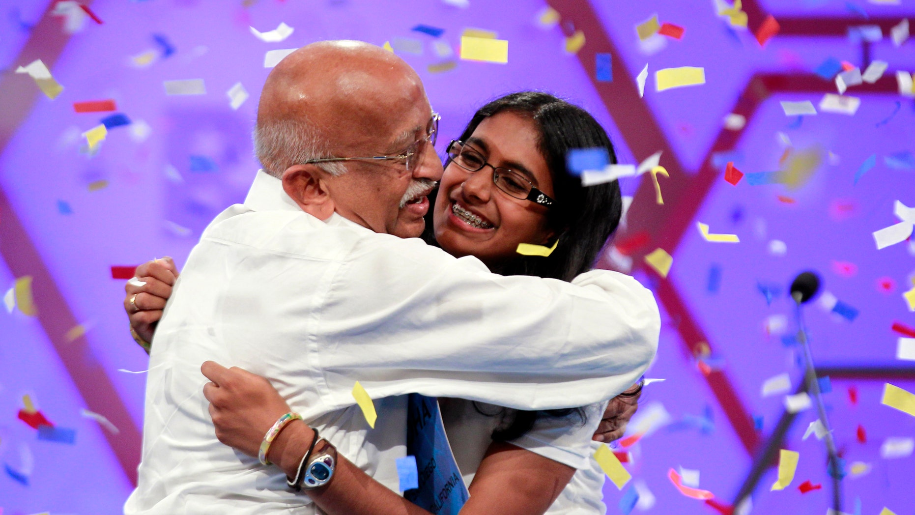 May 31, 2012: Snigdha Nandipati, 14, of San Diego, reacts with her grandfather from India, after winning the National Spelling Bee in Oxon Hill, Md.