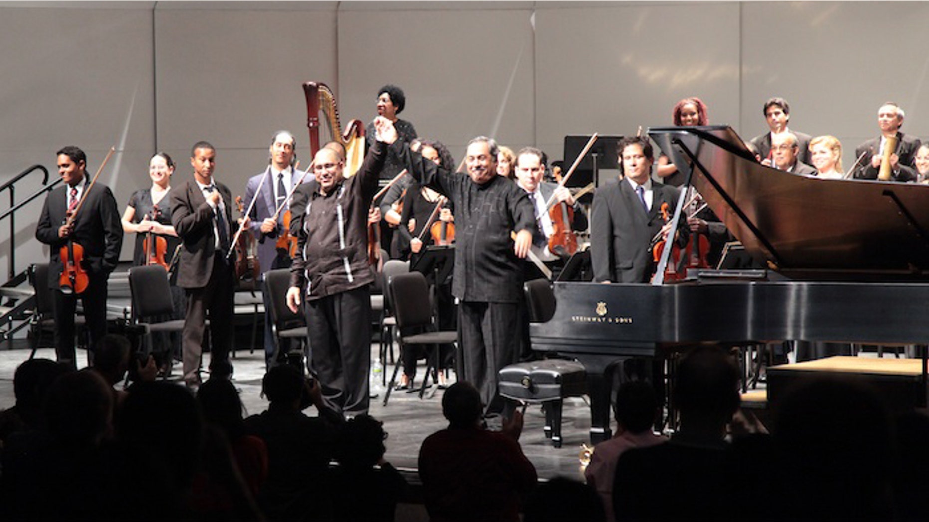 Nacho Herrera and Enrique Perez Mesa, along with the National Symphony Orchestra of Cuba, receive the applause of the audience in the Bronx