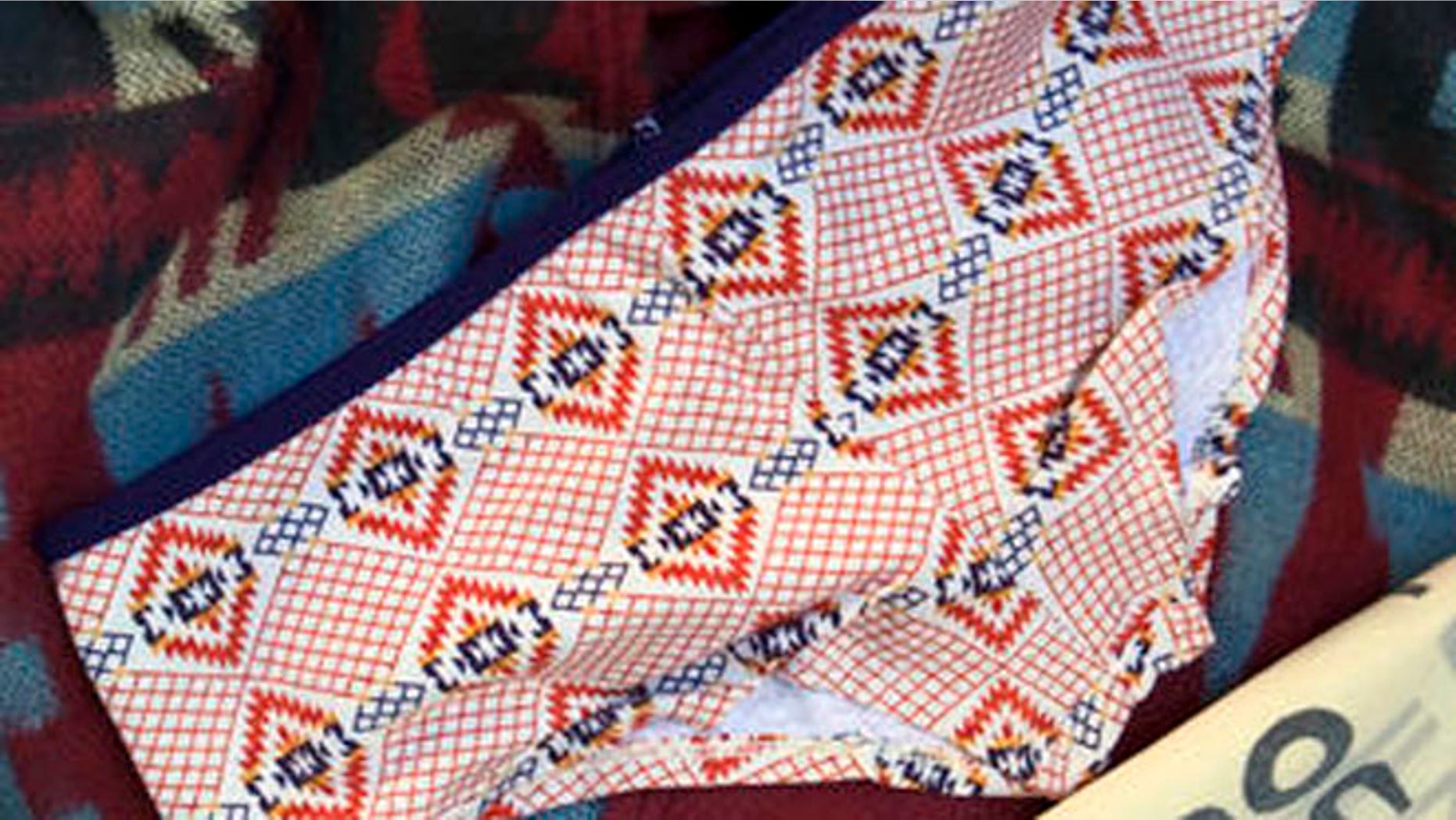 FILE - This Oct. 14, 2011, file photo shows purchased items from Urban Outfitters Navajo line in Tempe, Ariz. A federal judge has cleared the way for the Navajo Nation to seek potentially millions of dollars in its 2012 lawsuit over the company's use of the "Navajo" name. U.S. District Judge Bruce Black ruled Thursday, March 31, 2016, that the tribe didn't unreasonably delay a trademark infringement challenge against the clothing retailer. (AP Photo/Matt York, File)