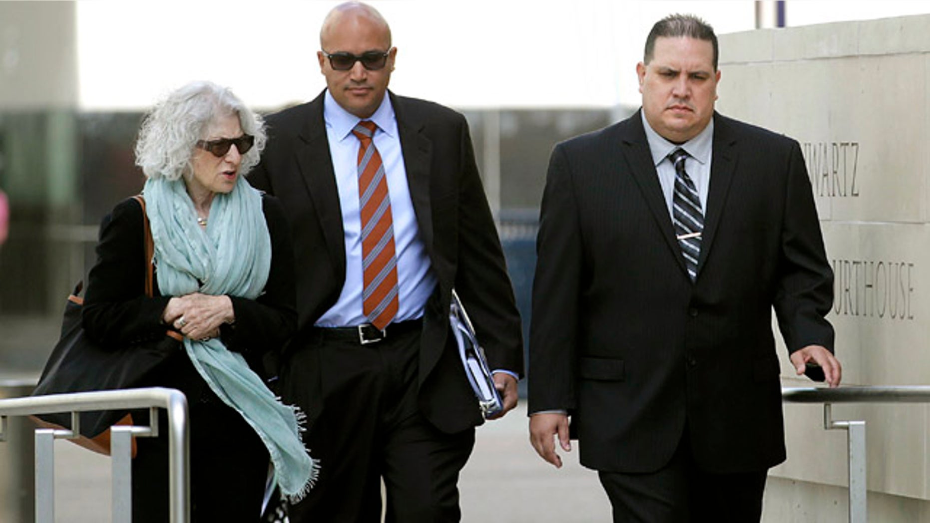 Nov. 20, 2013: Navy Cmdr. Jose Luis Sanchez, right, walks with unidentified individuals in San Diego. Sanchez pleaded guilty Tuesday in a massive bribery scheme involving a longtime military contractor in Asia who allegedly offered luxury travel, prostitutes and other bribes to Navy officers in exchange for confidential information. (AP Photo/U-T San Diego, John Gastaldo )