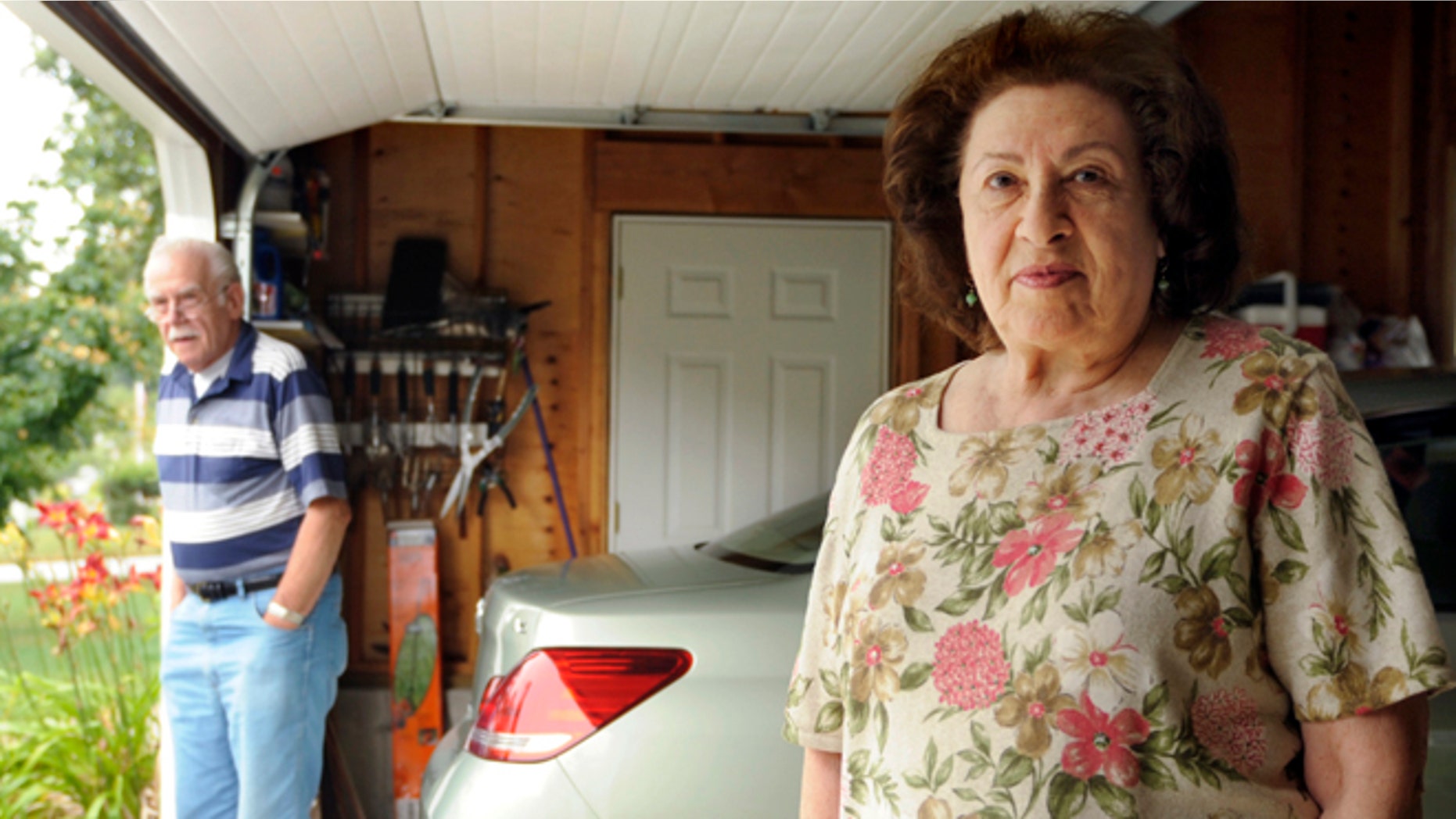 In this July 20, 2012 photo, Al, left, and Sondra Tuchman stand in the garage of their Montville, Conn., home. Sondra Tuchman said her garage-door opener was no longer opening and closing the door, and a representative of the door company told her they had received similar complaints from customers in nearby towns. The U.S. Navy said Monday, July 23, 2012, that a new radio system at the Naval Submarine Base in Groton may be interfering with the garage-door openers. (AP Photo/Sean D. Elliot, The Day) MANDATORY CREDIT: SEAN D. ELLIOT/THE DAY