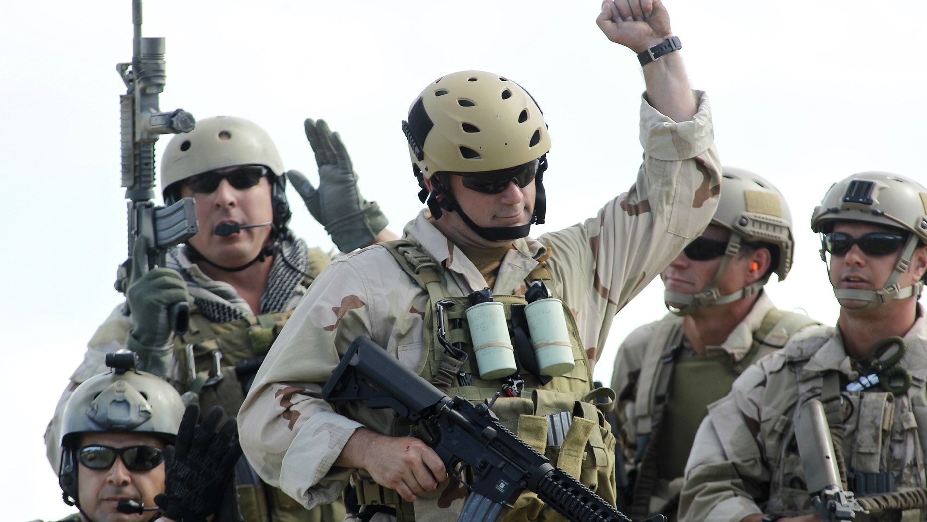 U.S. Navy SEAL Team 18 members react in recognition of contributions of former SEALS after a demonstration of combat skills at the National Navy UDT-SEAL Museum in Fort Pierce, Florida.