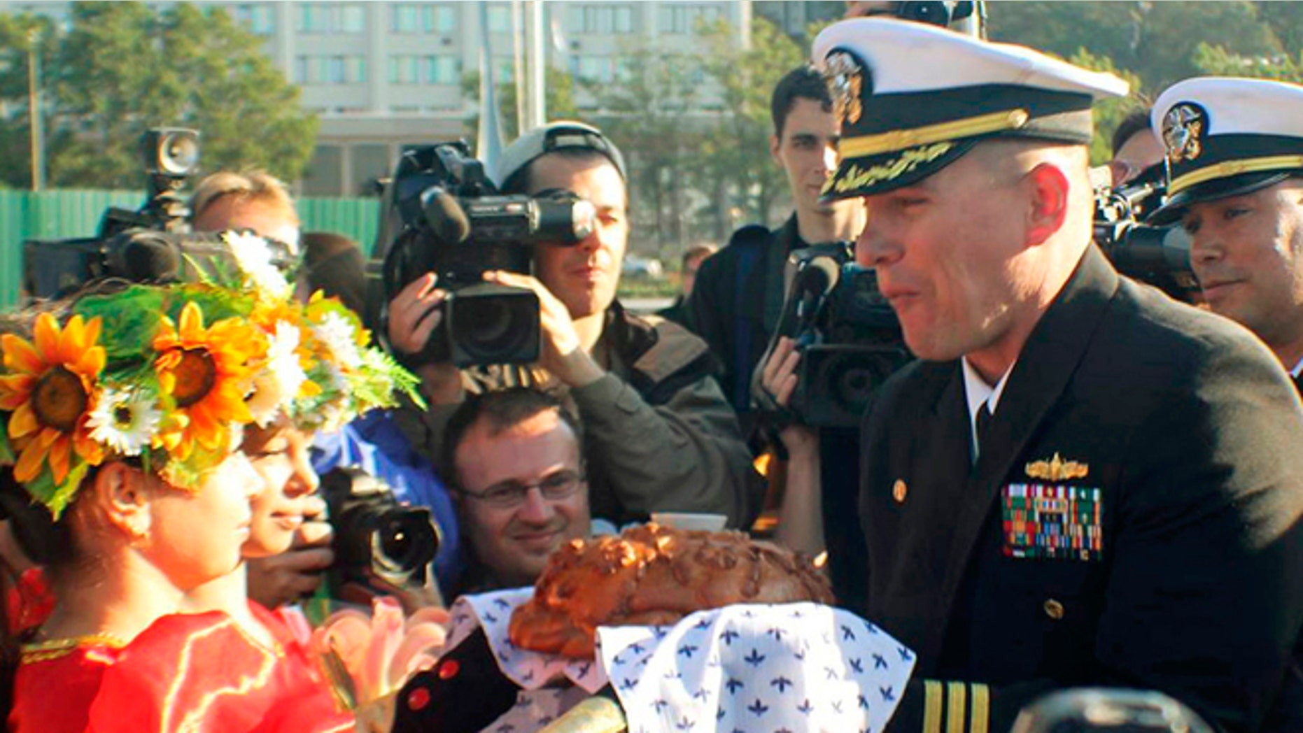 FILE 2012: Cmdr. Joseph R. Darlak, right foreground, was relieved of command in San Diego after an investigation for demonstrating poor leadership and failing to ensure proper officer conduct during the three-day September stop.