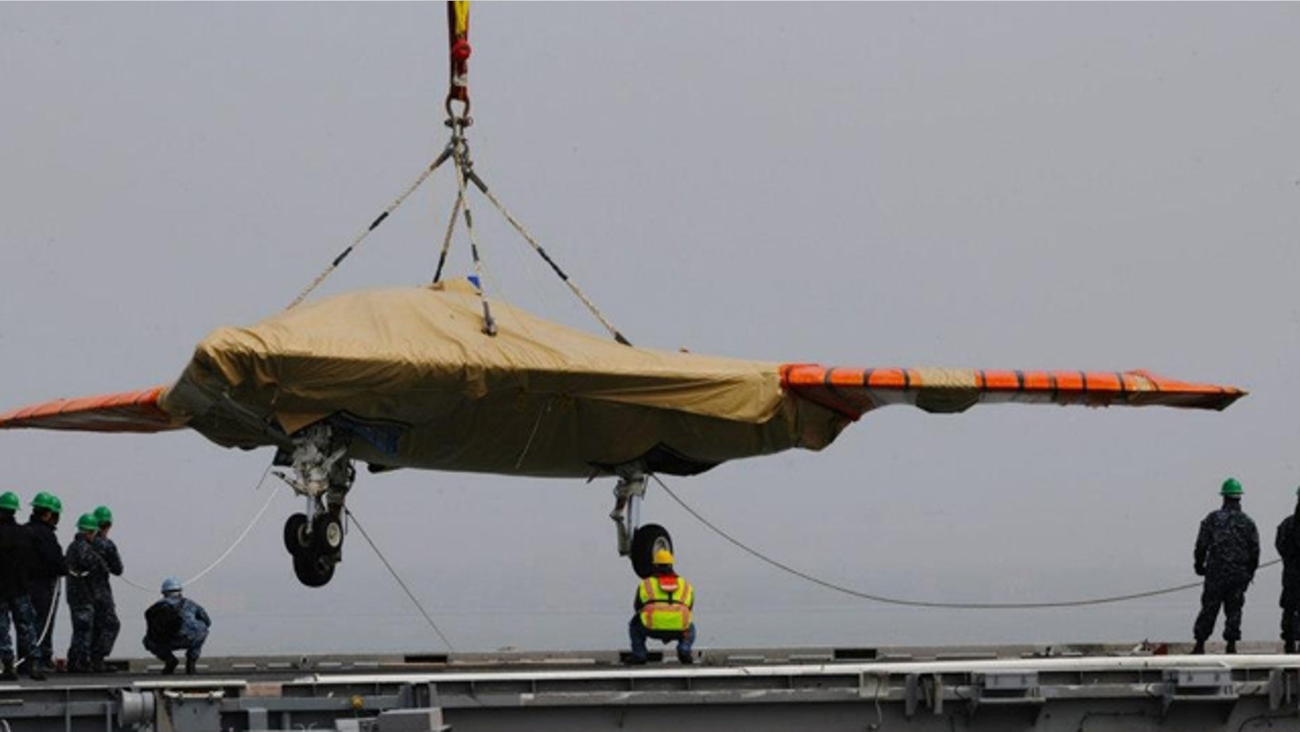 May 6, 2013: A X-47B Unmanned Combat Air System demonstrator is loaded onto the flight deck of the aircraft carrier USS George H.W. Bush.
