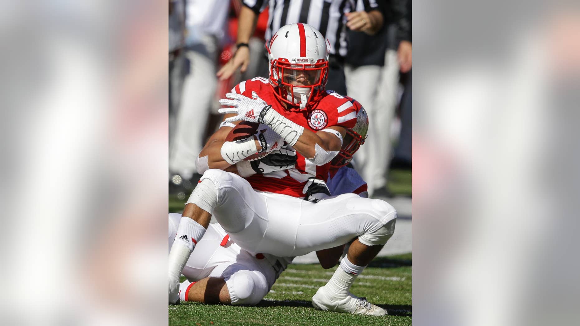 Nebraska wide receiver Kenny Bell, front, is tackled by Rutgers defensive back Andre Hunt after Bell made a catch, in the second half of an NCAA college football game in Lincoln, Neb., Saturday, Oct. 25, 2014. Bell enjoys throwing downfield blocks as much as catching passes. (AP Photo/Nati Harnik)