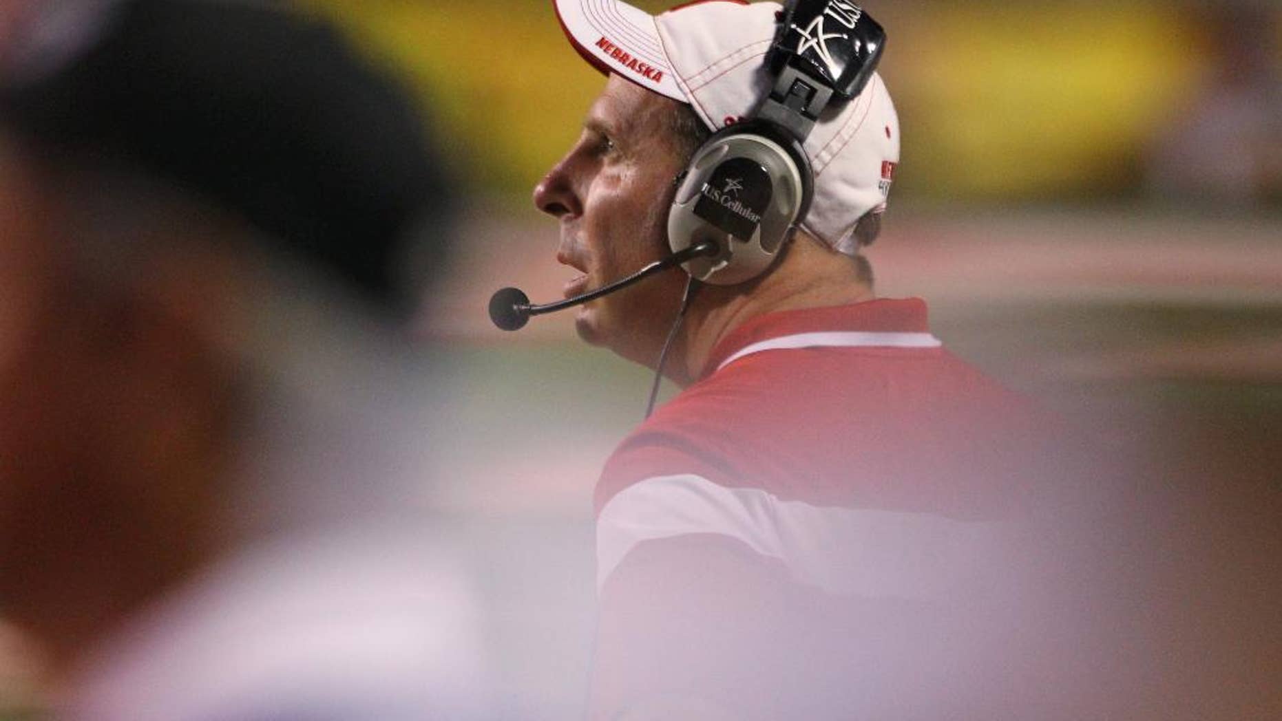 Nebraska's Bo Pelini checks the scoreboard against Fresno State in the second half of an NCAA college football game in Fresno, Calif., Saturday, Sept. 13, 2014. (AP Photo/Gary Kazanjian)