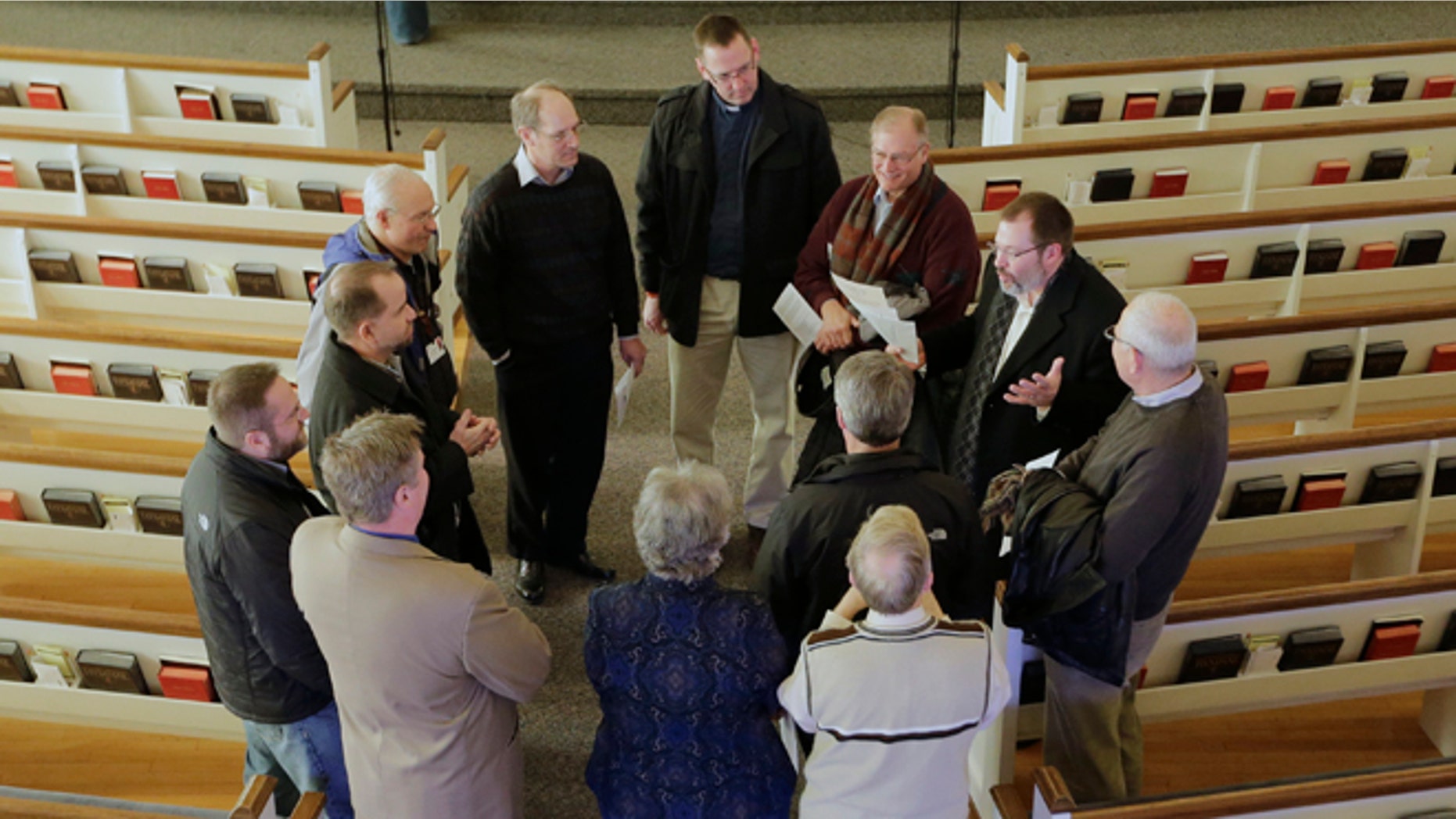 In this Thursday, Feb. 6, 2014 photo, religious leaders of various denominations in Fremont, Neb., meet at the First United Methodist Church, following a service, part of 40 Days of Prayer for Fremont. The prayer and meeting comes ahead of a special election Tuesday, Feb. 11, to decide whether to drop housing restrictions against undocumented immigrants, as had been approved by Fremont voters in the 2010 elections. The city leaders scheduled the special election because of concerns the housing restrictions could cost them millions in federal grants and lead to more lawsuits against the city. (AP Photo/Nati Harnik)