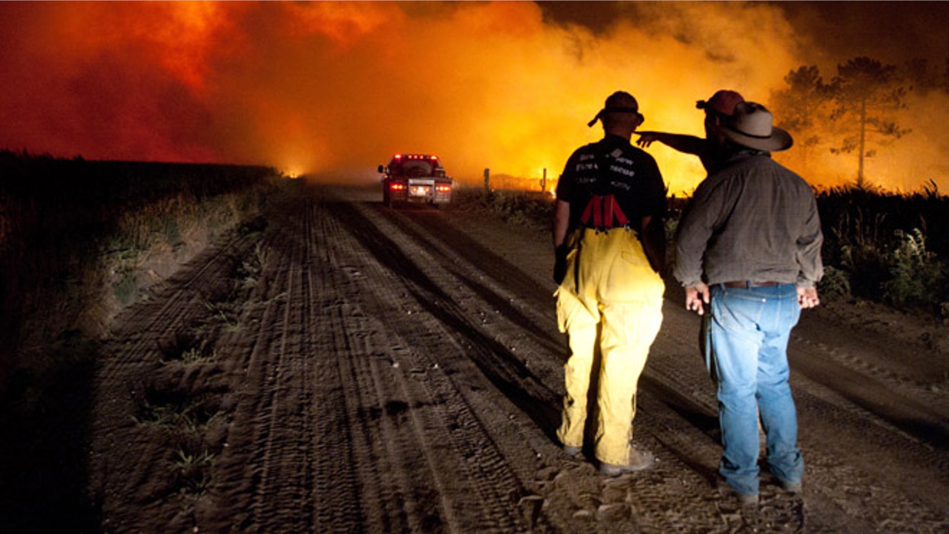 July 24: Firefighters plan an attack at the Fairfield Creek fire near Springview, Neb.