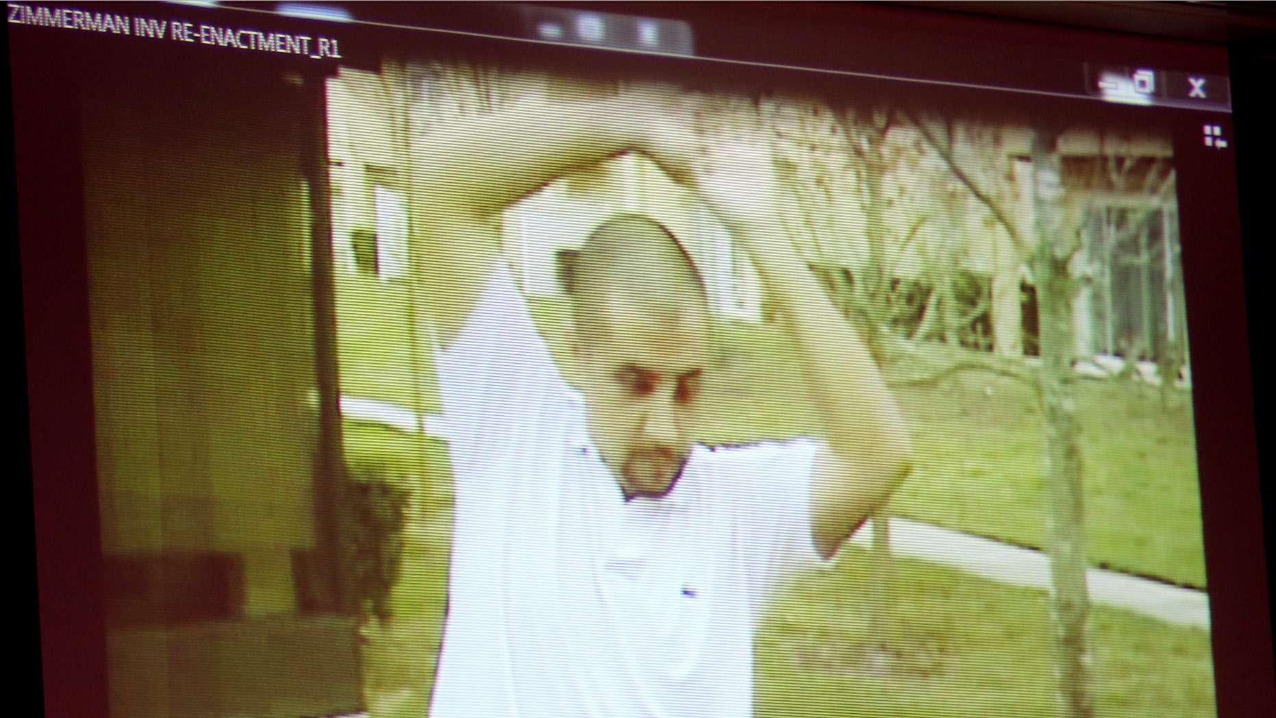 A reenactment video shows George Zimmerman with Sanford police investigators, taken the after the Trayvon Martin shooting, is projected for the jury during the 16th day of his trial in Seminole circuit court, in Sanford, Fla., Monday, July 1, 2013. Zimmerman has been charged with second-degree murder for the 2012 shooting death of Trayvon Martin.(AP Photo/Orlando Sentinel, Joe Burbank, Pool)