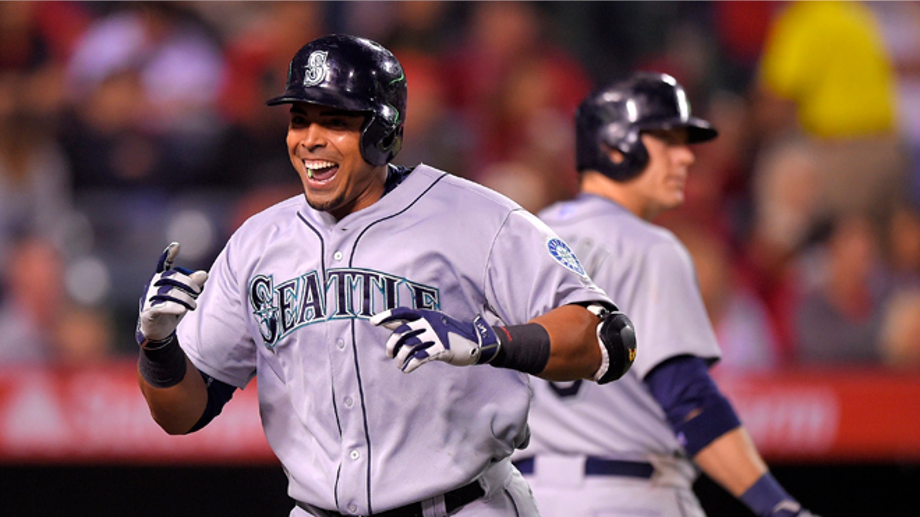 Seattle Mariners' Nelson Cruz, left, celebrates after hitting a solo home run against the Los Angeles Angels as Logan Morrison walks up to bat during the seventh inning of a baseball game, Monday, May 4, 2015, in Anaheim, Calif. Morrison also hit a solo home run in the inning. (AP Photo/Mark J. Terrill)