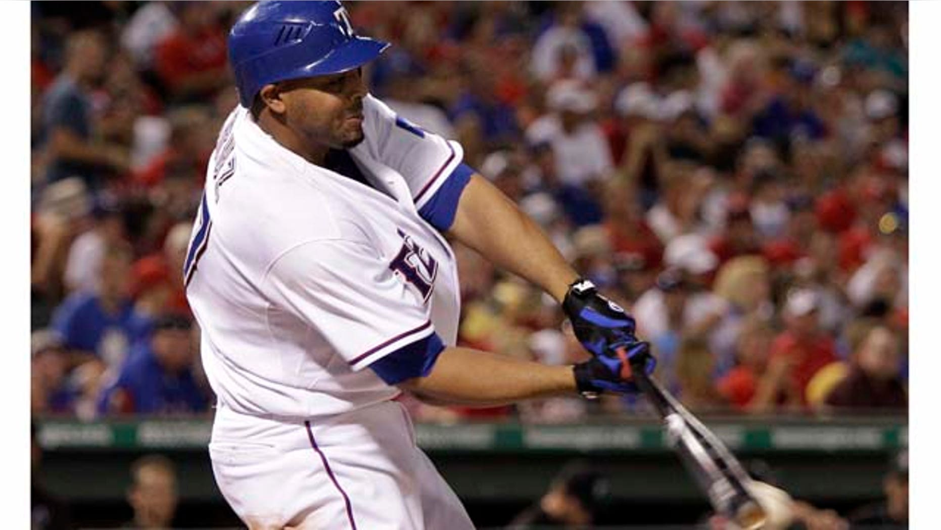 Texas Rangers' Nelson Cruz connects for an two-run single off Toronto Blue Jays reliever Shawn Camp in the sixth inning of a baseball game on Friday, July 22, 2011, in Arlington, Texas. Cruz had eight RBIs in the 12-2 Rangers win. (AP Photo/Tony Gutierrez)
