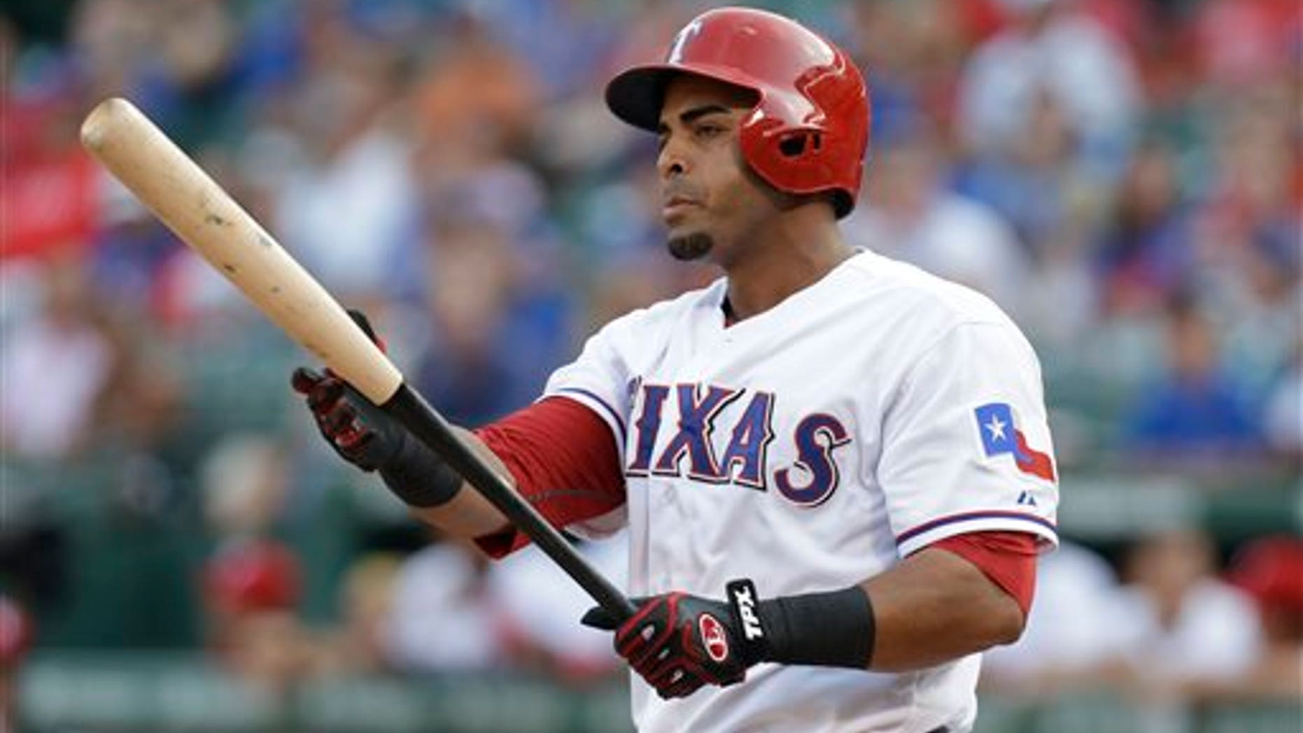 In this Aug. 1, 2013, photo, Texas Rangers' Nelson Cruz prepares for his at-bat during the second inning of a baseball game against the Arizona Diamondbacks in Arlington, Texas. A person familiar with the deal tells The Associated Press that Cruz, a free agent, and the Baltimore Orioles have reached agreement on a one-year contract. The person spoke Saturday, Feb. 22, 2014, on condition of anonymity because the contract was not complete. Cruz will earn about $8.5 million, and can make more in performance bonuses. Other media outlets had reported a deal was in place. (AP Photo/LM Otero)