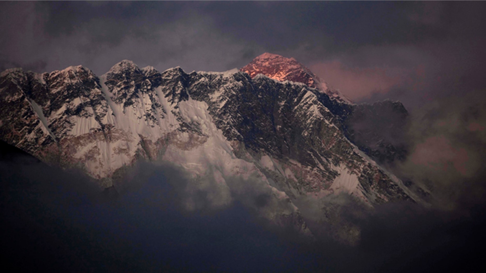 FILE - In this Oct. 27, 2011 file photo, the last light of the day sets on Mount Everest as it rises behind Mount Nuptse as seen from Tengboche in the Himalays, Khumbu region, Nepal. (AP Photo/Kevin Frayer, File)