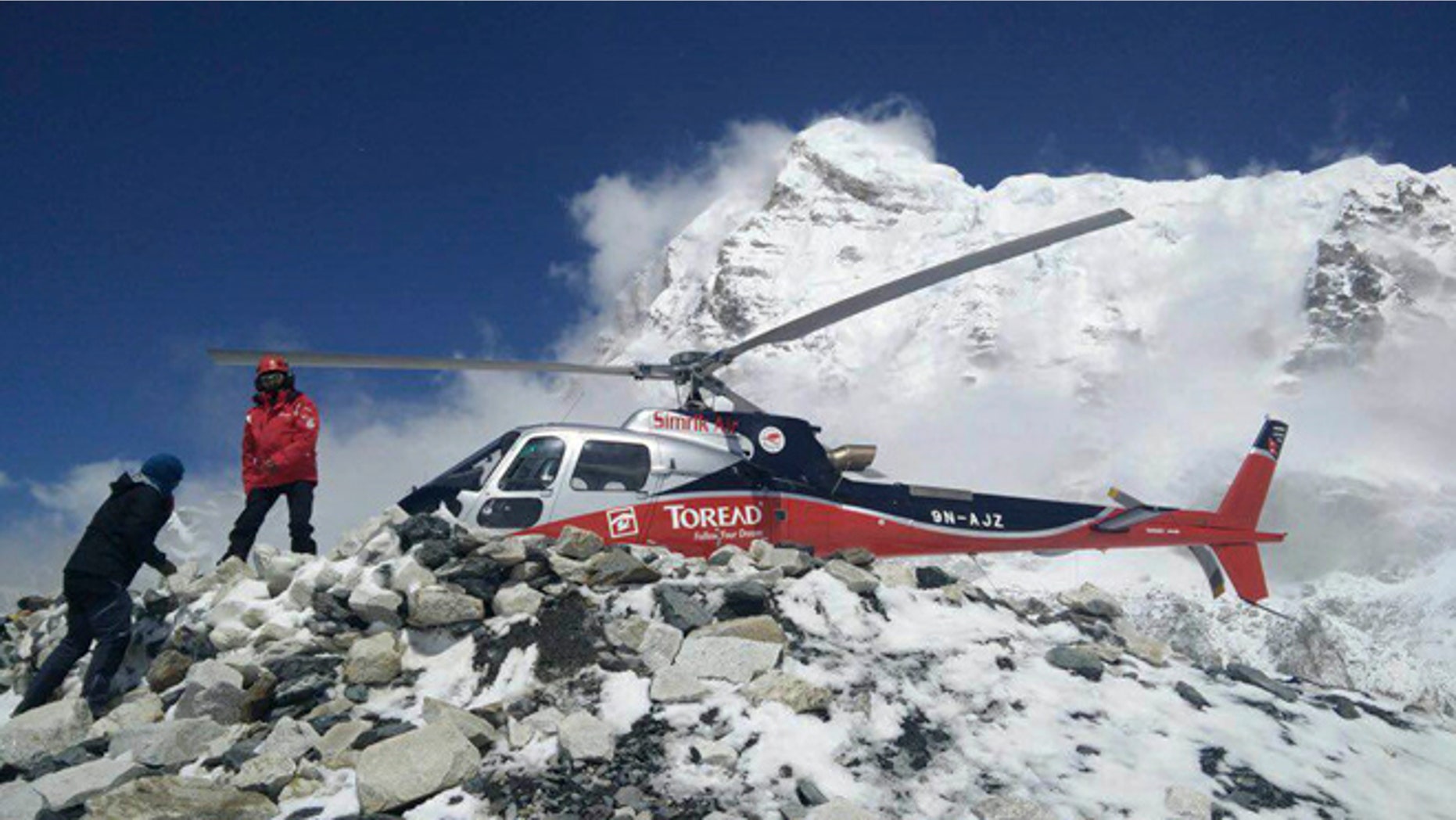 A helicopter prepares to rescue people from camp 1 and 2 at Everest Base Camp, Nepal. On Monday, State Department officials confirmed the death of two Americans at the base camp from a large avalanche triggered by Nepal's massive earthquake. (Azim Afif via AP)