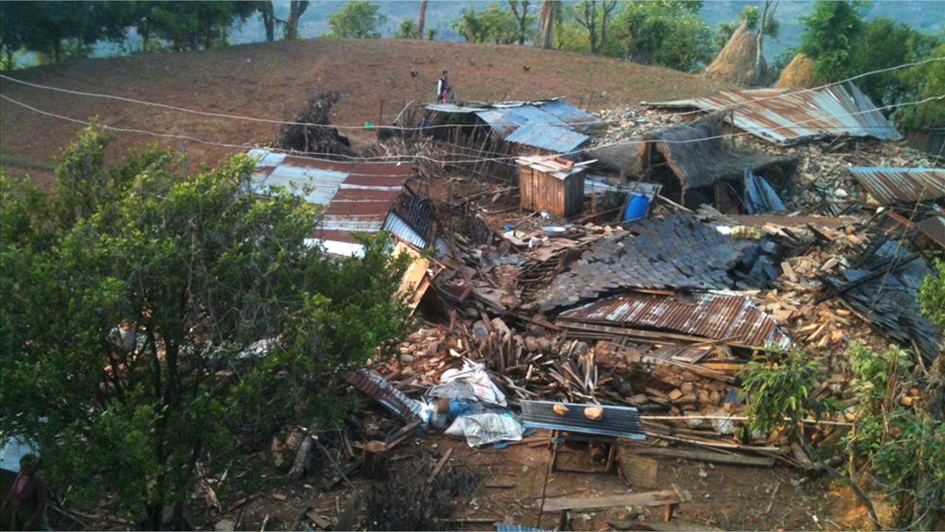 In this photo provided by World Vision, houses lie destroyed by Saturdayâs earthquake at Paslang village in Gorkha municipality, Nepal, Monday, April 27, 2015. Reports received so far by the government and aid groups suggest that many communities perched on mountainsides are devastated or struggling to cope. Udav Prashad Timalsina, the top official for the Gorkha district, near the epicenter of Saturday's quake, said he was in desperate need of help. (Bishwo Ghimire/World Vision via AP)