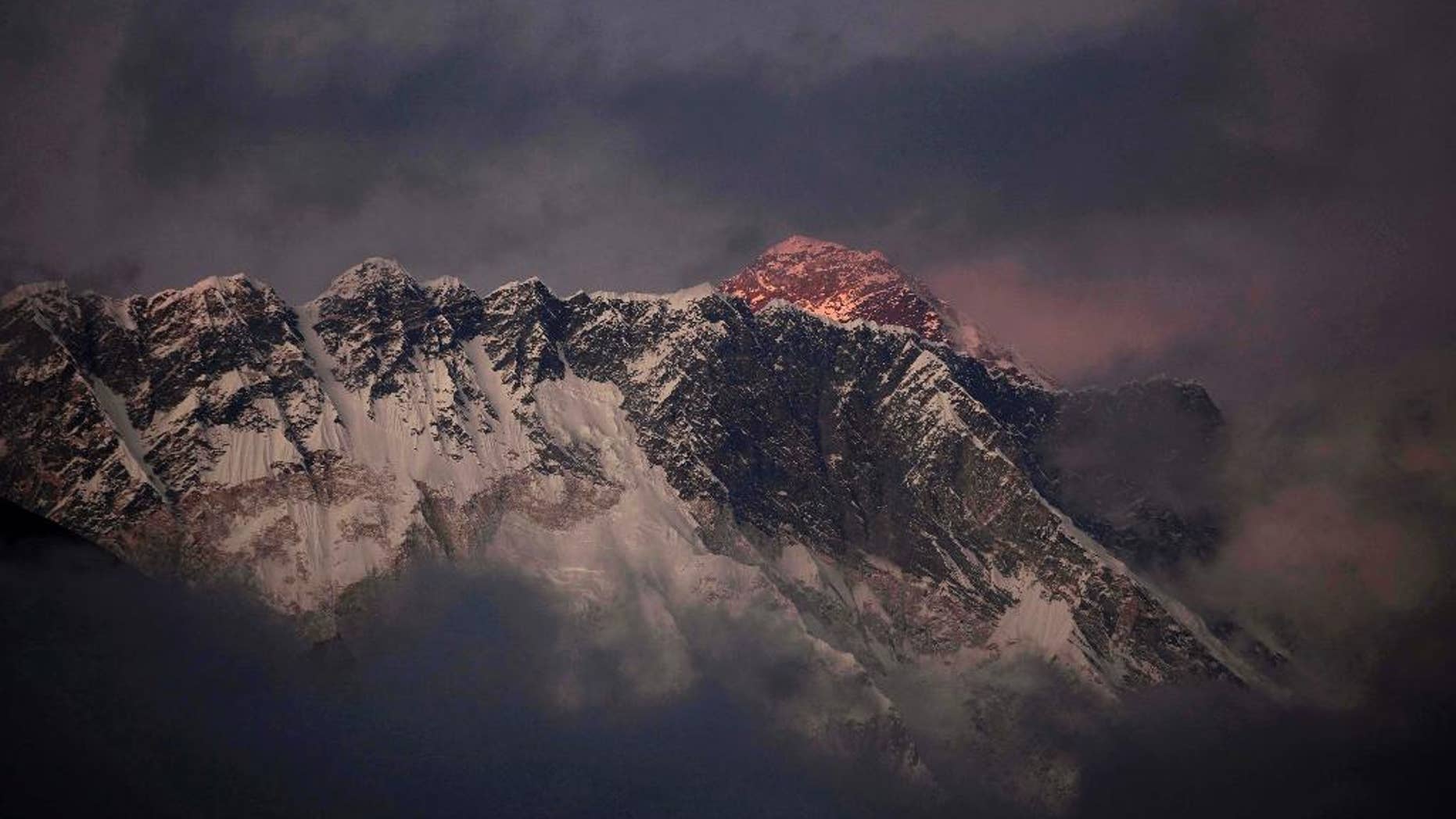 FILE - In this Oct. 27, 2011 file photo, the last light of the day sets on Mount Everest as it rises behind Mount Nuptse as seen from Tengboche, in the Himalaya's Khumbu region, Nepal. Nepal is improving weather forecasting systems, stepping up security and promises swift rescues if needed during the upcoming climbing season on Everest in attempt to recover from the worst mountaineering disaster on the world’s highest peak last year, officials said Monday. (AP Photo/Kevin Frayer, File)