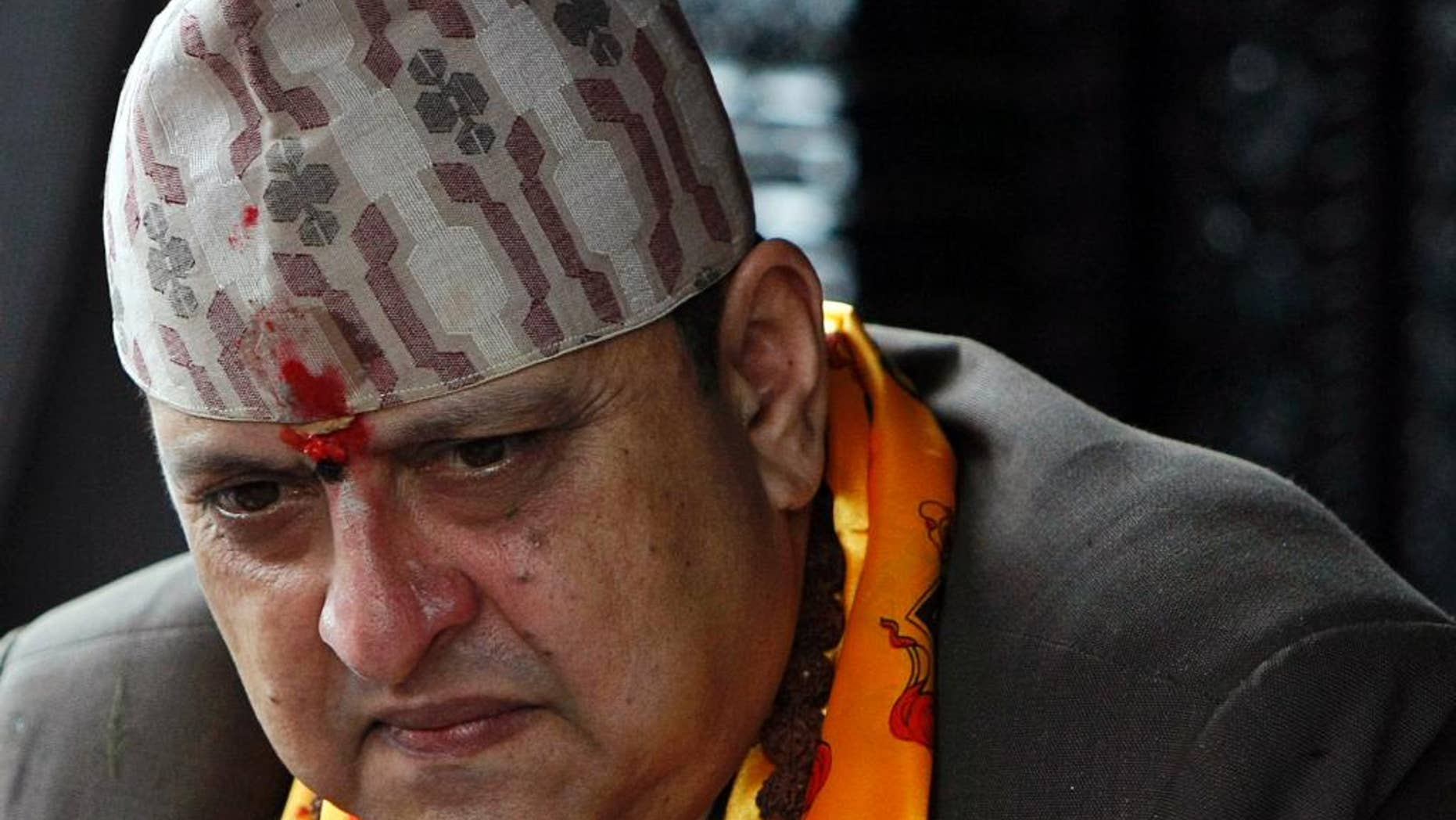 FILE - In this July 7, 2011 file photo, Nepal's former King Gyanendra listens to a supporter on his 64th birthday at his residence in Katmandu, Nepal. The last king of Nepal is in stable condition in a hospital after suffering a heart attack, doctors said Sunday, Sept. 21, 2014. (AP Photo/Binod Joshi)