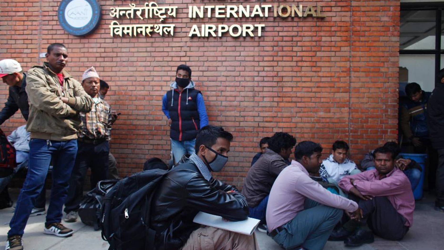 Stranded passengers wait for an update on their flights at Tribhuwan International Airport in Kathmandu, Nepal, Wednesday, March 4, 2015. A Turkish Airlines jet landing in dense fog in the Nepalese capital Wednesday skidded off a slippery runway but there were no serious injuries, officials said. The only international airport in Nepal remained closed Wednesday morning after the accident. (AP Photo/Niranjan Shreshta)